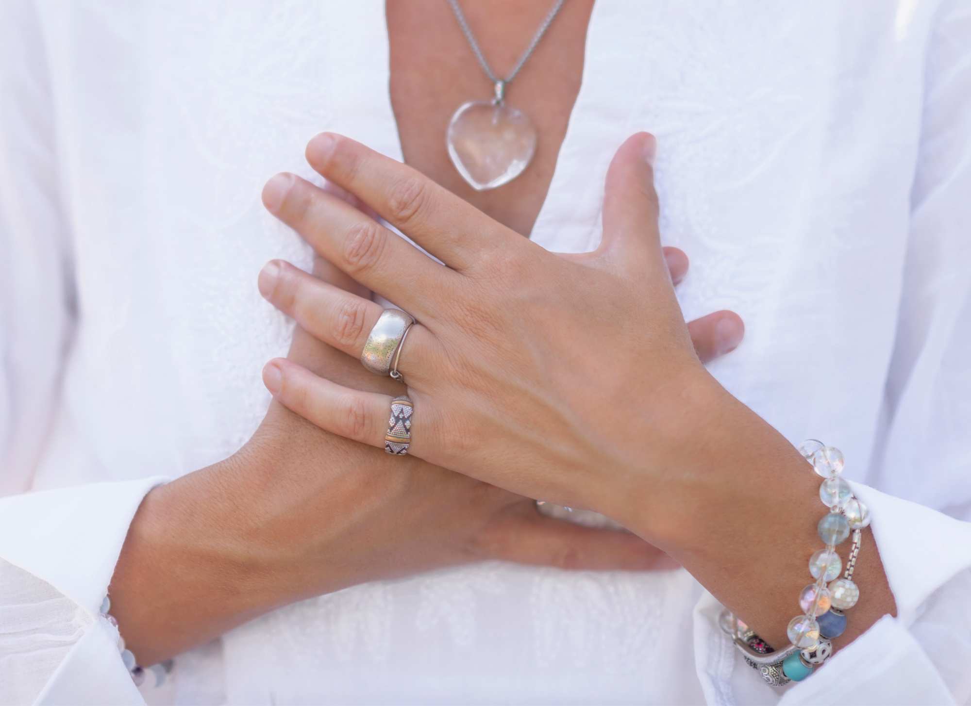 woman holding hands over chest