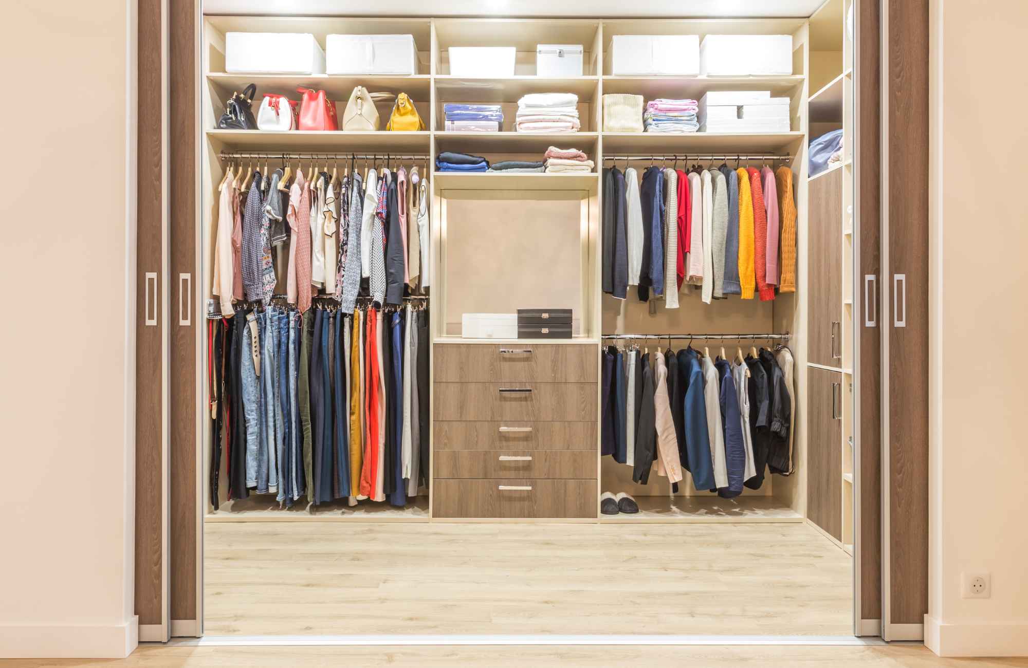 professional-home-organizer-parkville-mo-reflecting-and-setting-business-goals-organized-closet-with-bright-light-hanging-clothes-drawers-and-shelves-for-storage-caring