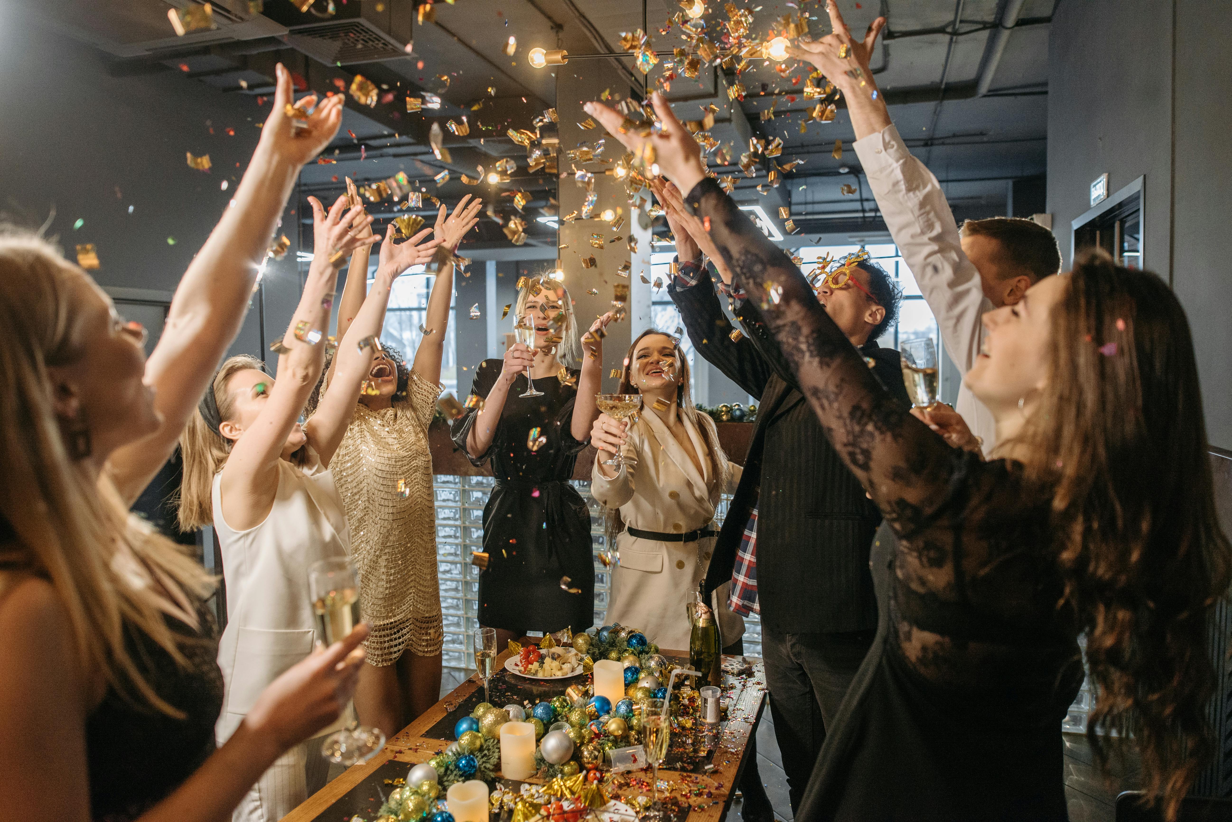 “Guests dancing and celebrating under cold sparklers, creating unforgettable memories at a Melora event.”