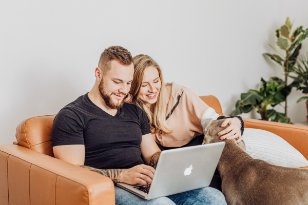 Couple on Computer, Couple Wedding Planning, Fiances with Dog