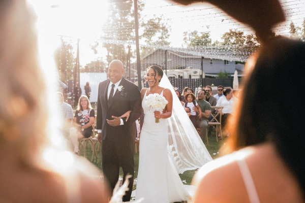 a bride and her father walking down the aisle