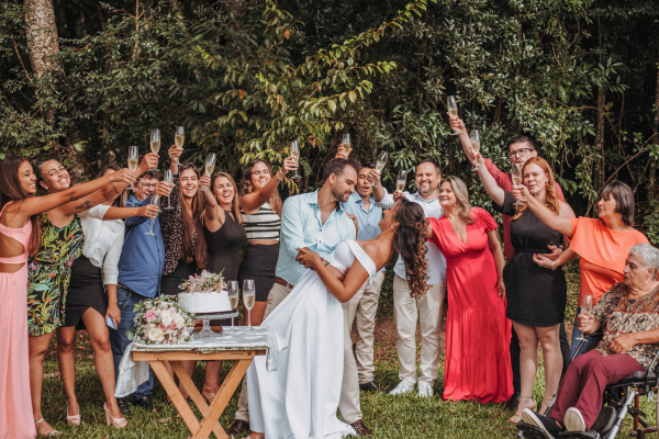 Couple kissing with guests cheering around them