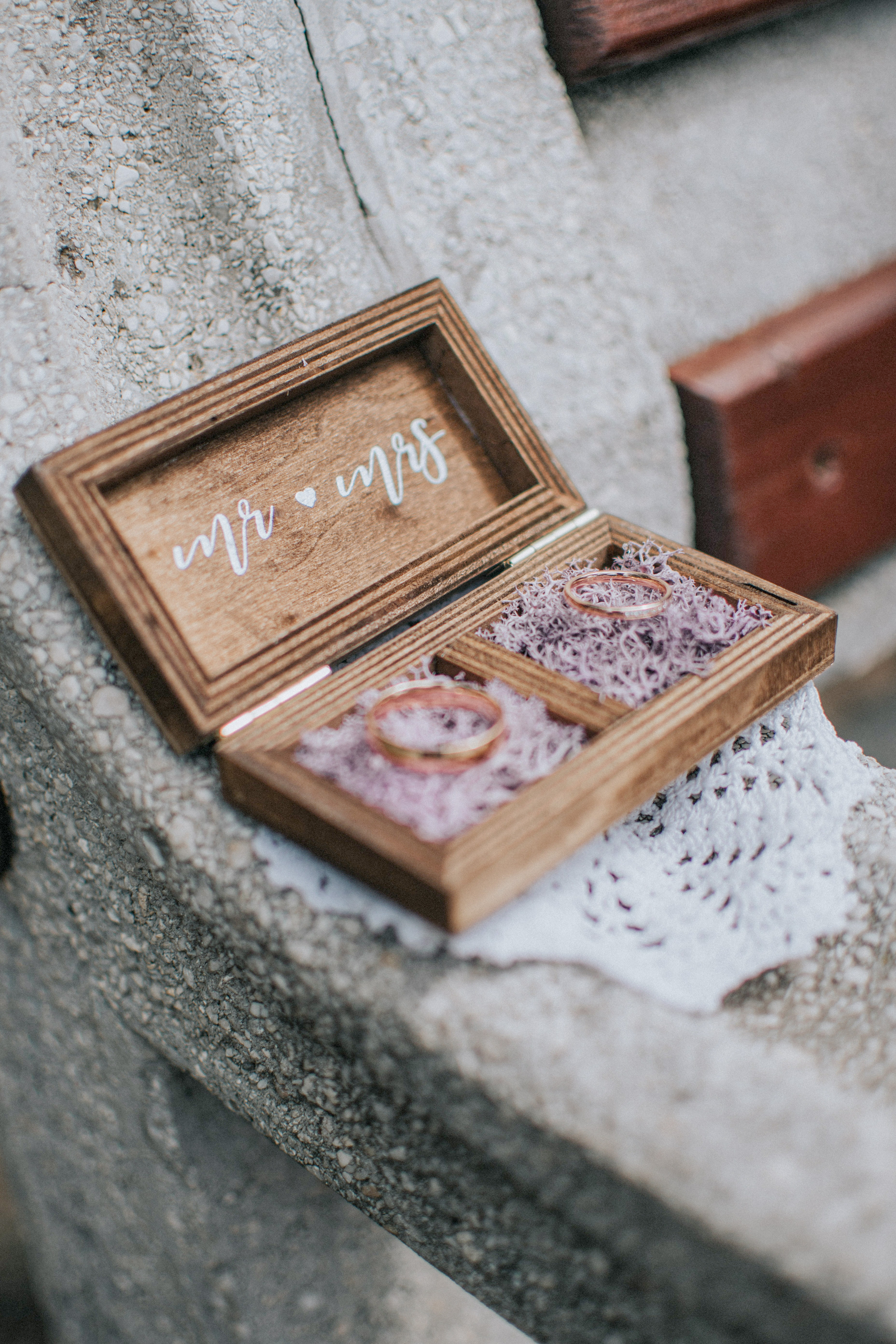 two wedding bands in wooden ring box