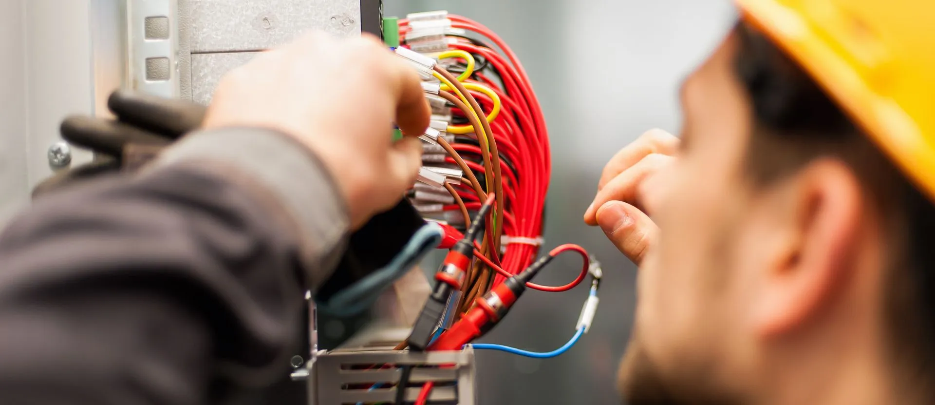 a close-up of a person's hands working with wires