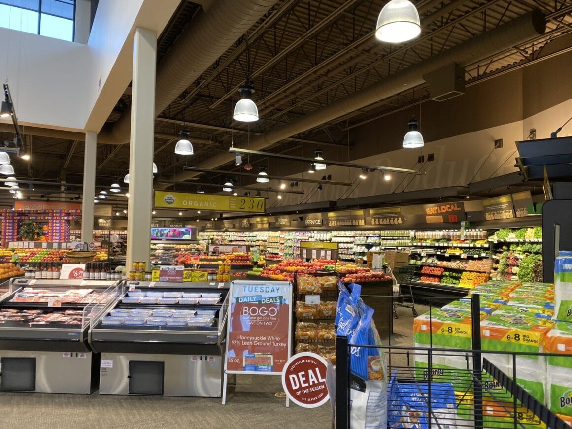 a grocery store with produce in the shelves