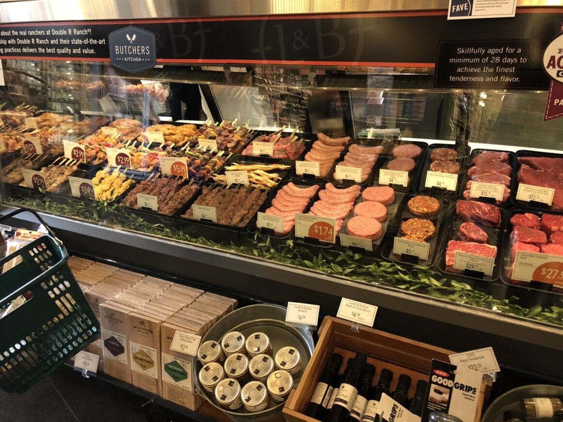 a display case with meats and drinks