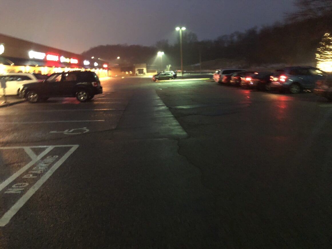 a parking lot with cars parked at night