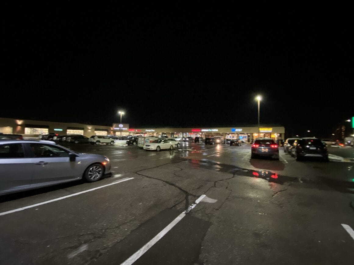 a parking lot with cars and cool lights at night