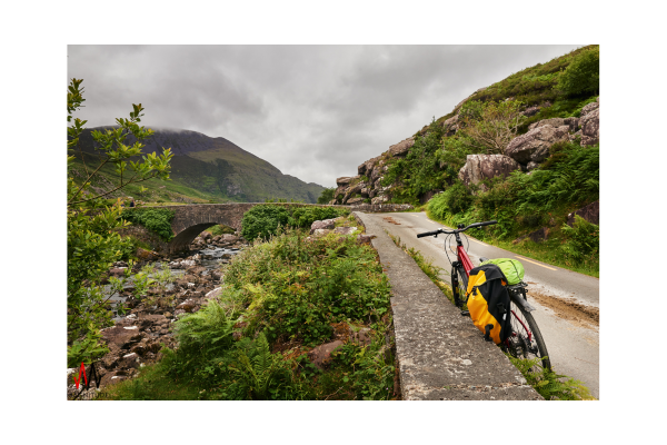 Bicycle on a Mountain Road: A bicycle leaning against a wall on a quiet mountain road, symbolizing simplicity and the joy of a balanced life.