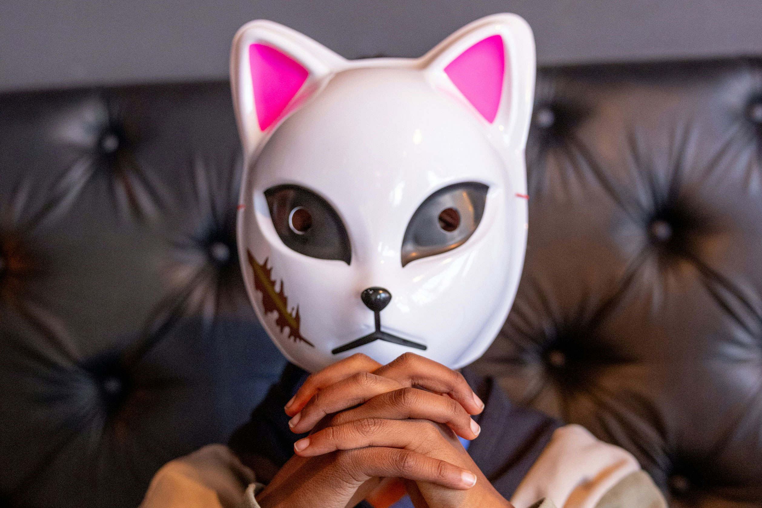 Person in a cat mask. Person in a cat mask.