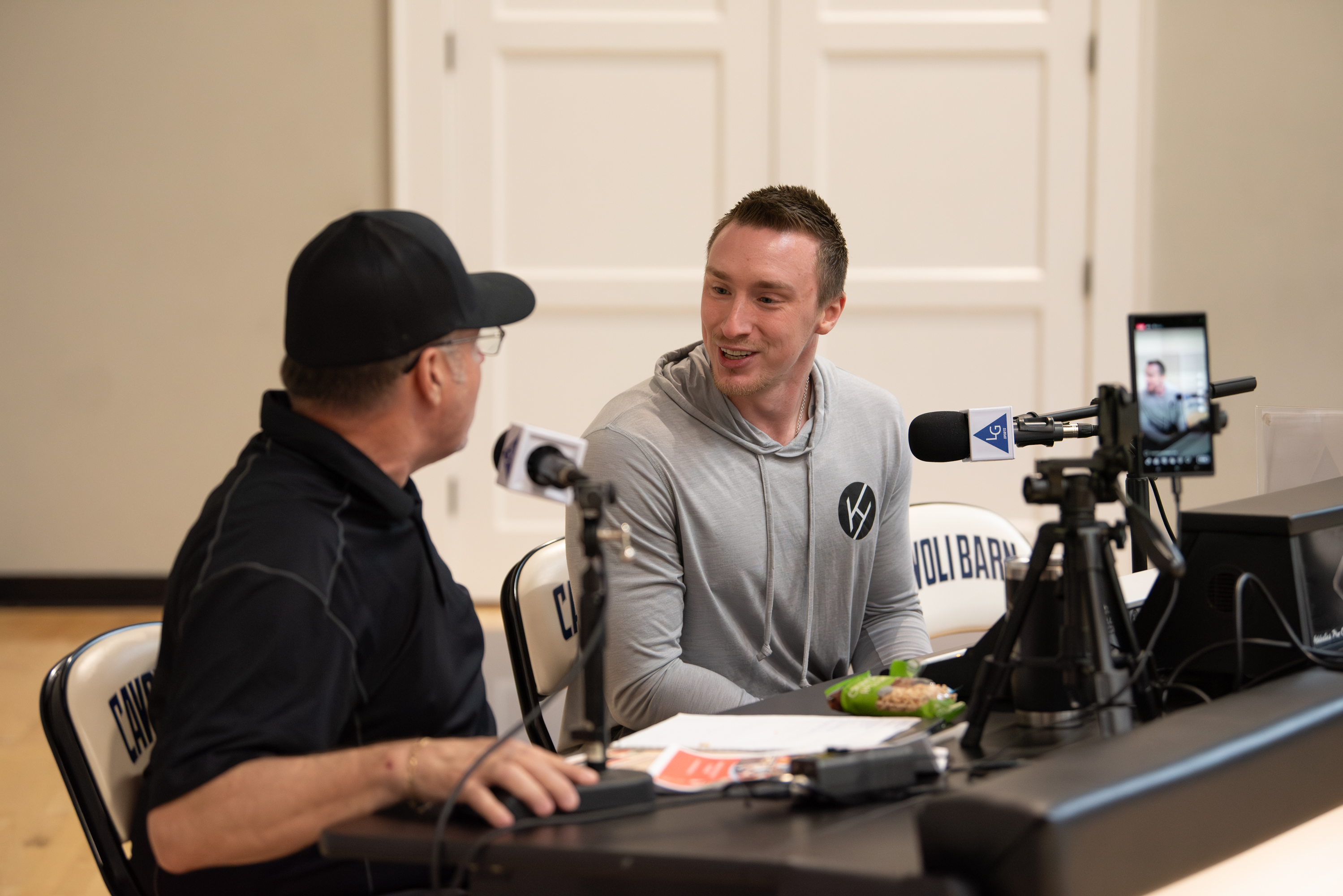 Kody Hartlaub speaking during a podcast interview about mental conditioning and performance coaching, sharing leadership strategies for athletes and business professionals