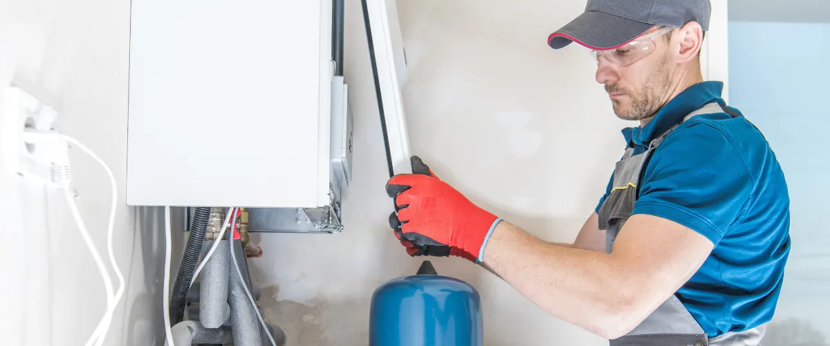 Technician performing water heater maintenance in Arizona