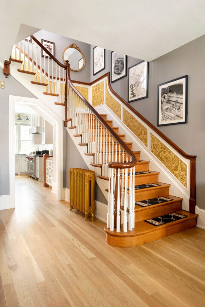 a staircase with art on the wall