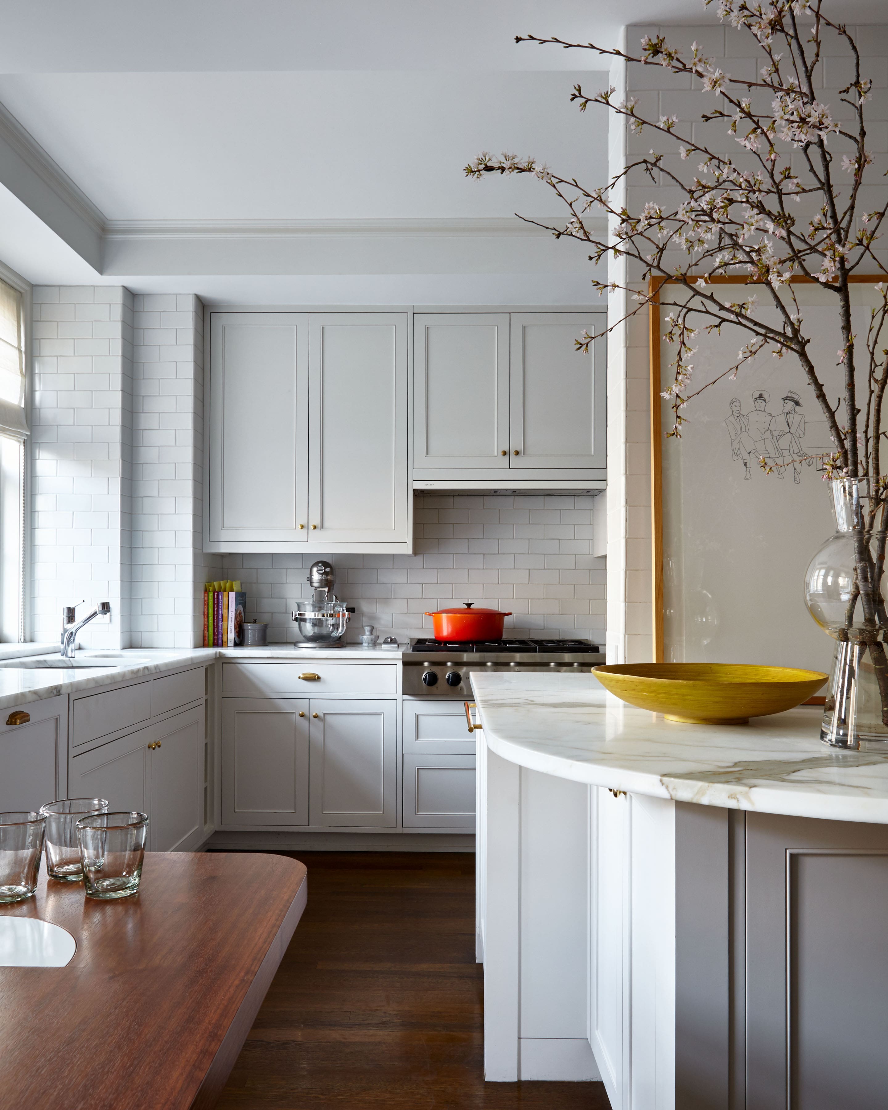 a kitchen with white cabinets and a table