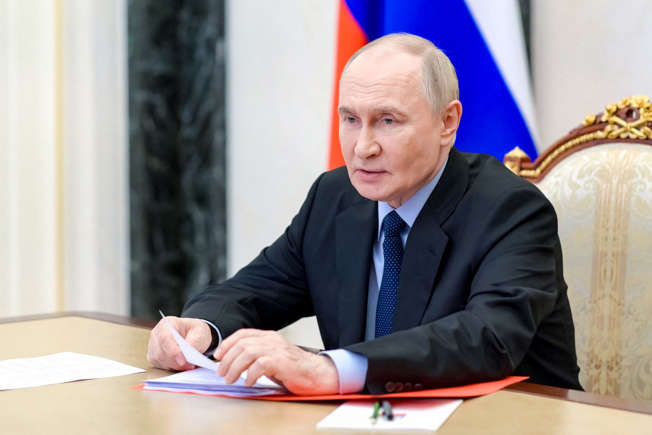 “Vladimir Putin seated at a formal meeting table, looking displeased, with Russian flags behind him — used in a news story about China’s controversial new territorial map.” “Vladimir Putin seated at a formal meeting table, looking displeased, with Russian flags behind him — used in a news story about China’s controversial new territorial map.”