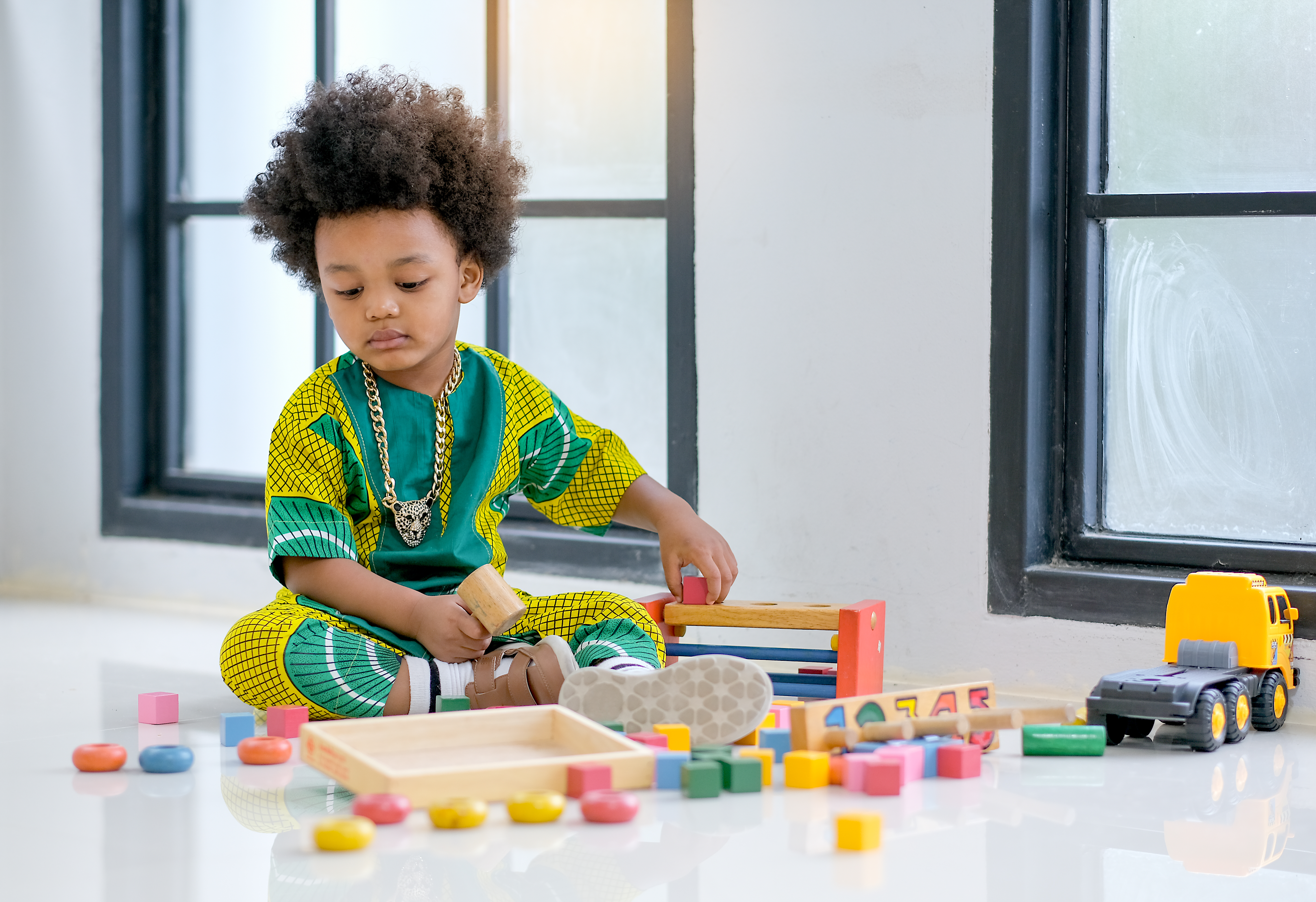 A boy is thinking of what shape, sizes and color to choose.