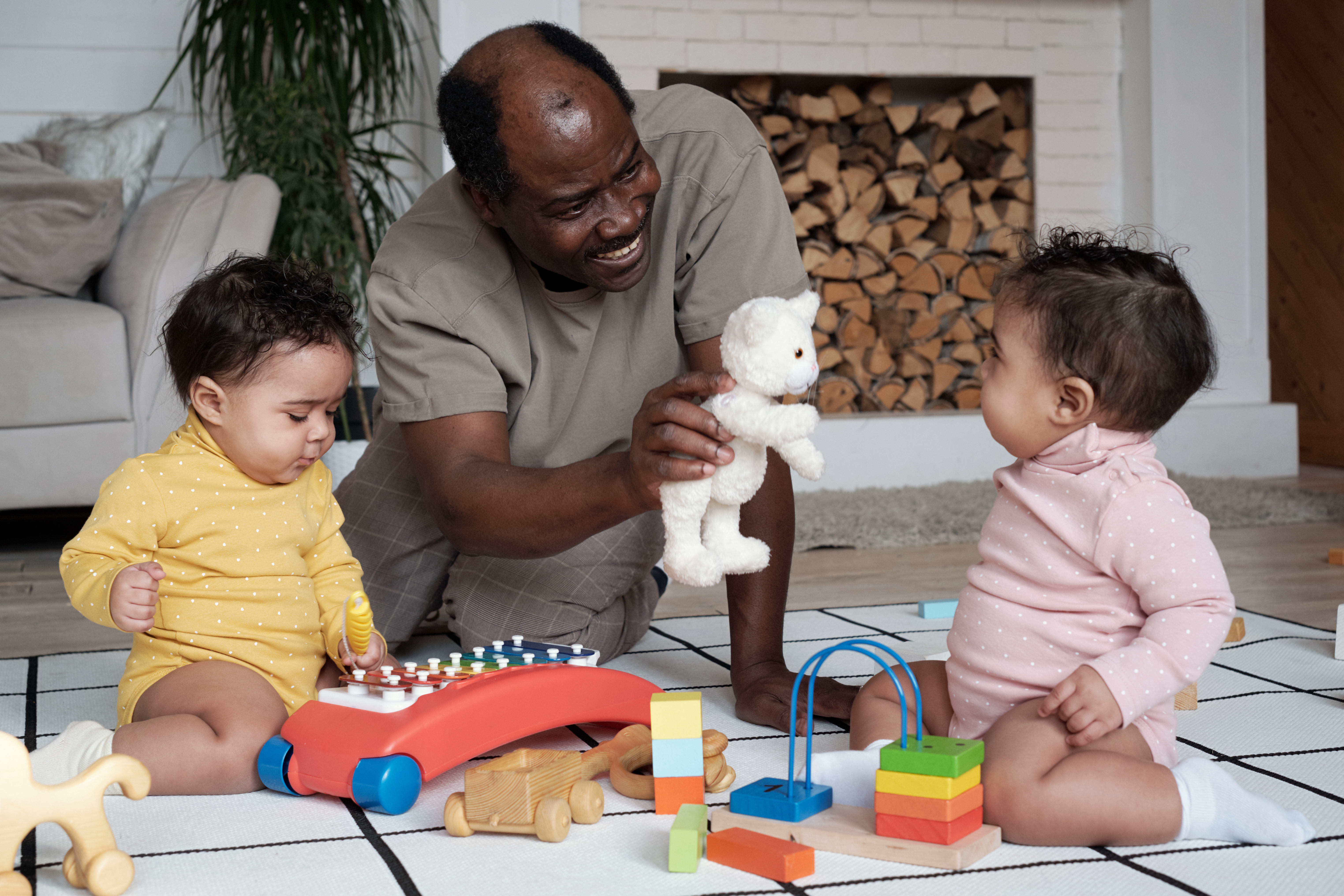 The father distracts his kids by showing them a new toy.