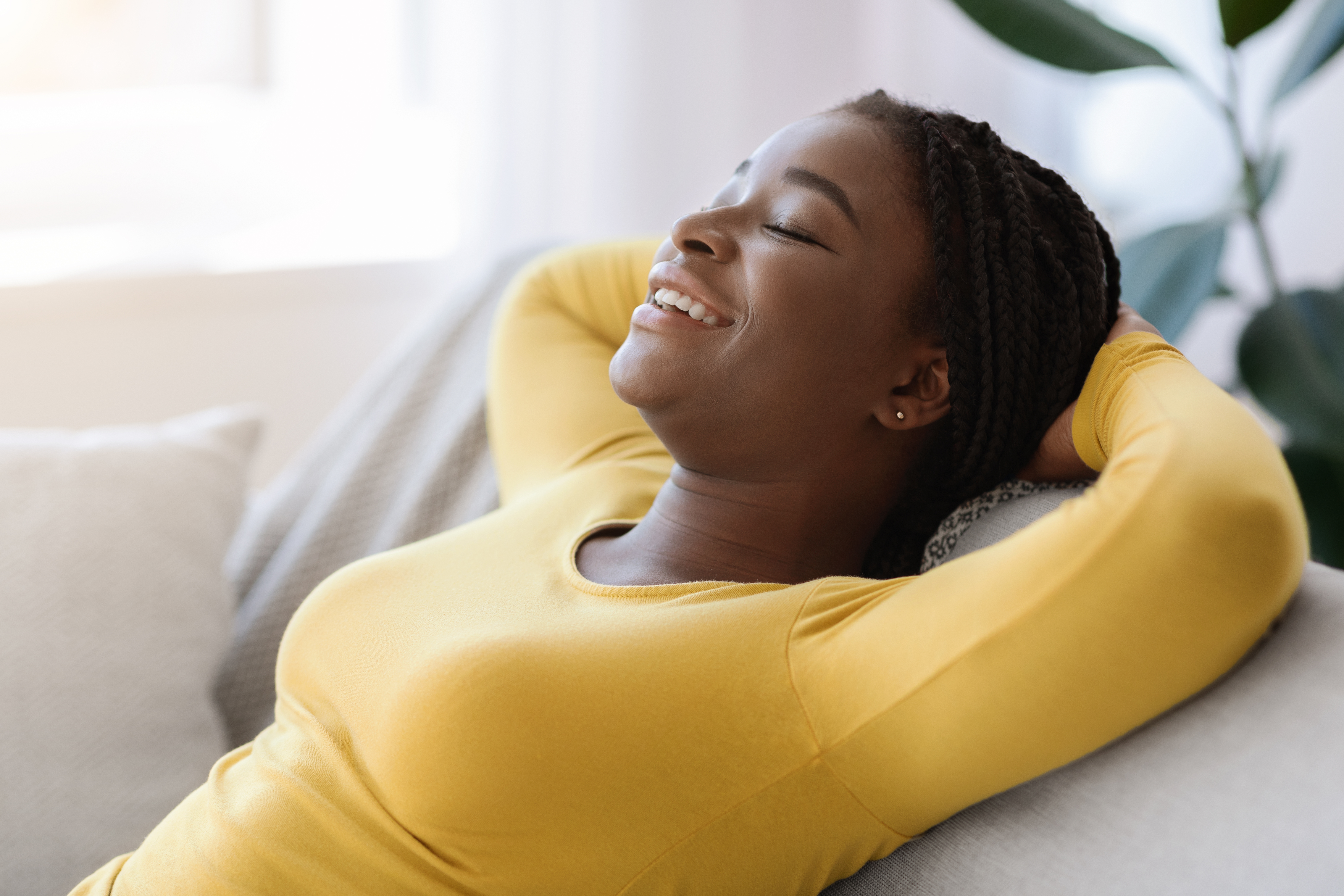 A mother sits calmly and contentedly, taking a moment to recharge and enjoy a peaceful moment.