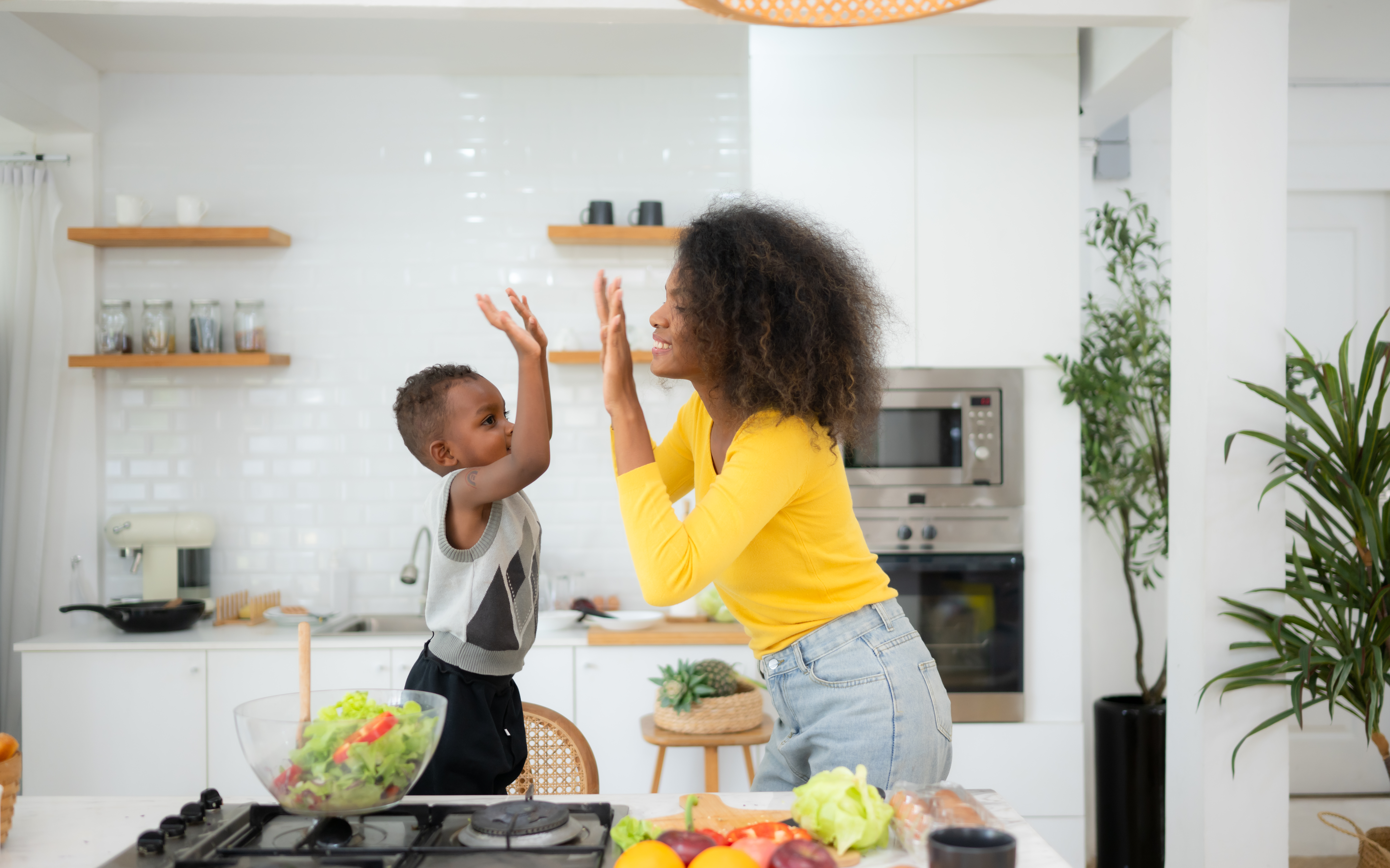 The mother gives her son credit for assisting with breakfast preparation. The mother gives her son credit for assisting with breakfast preparation.