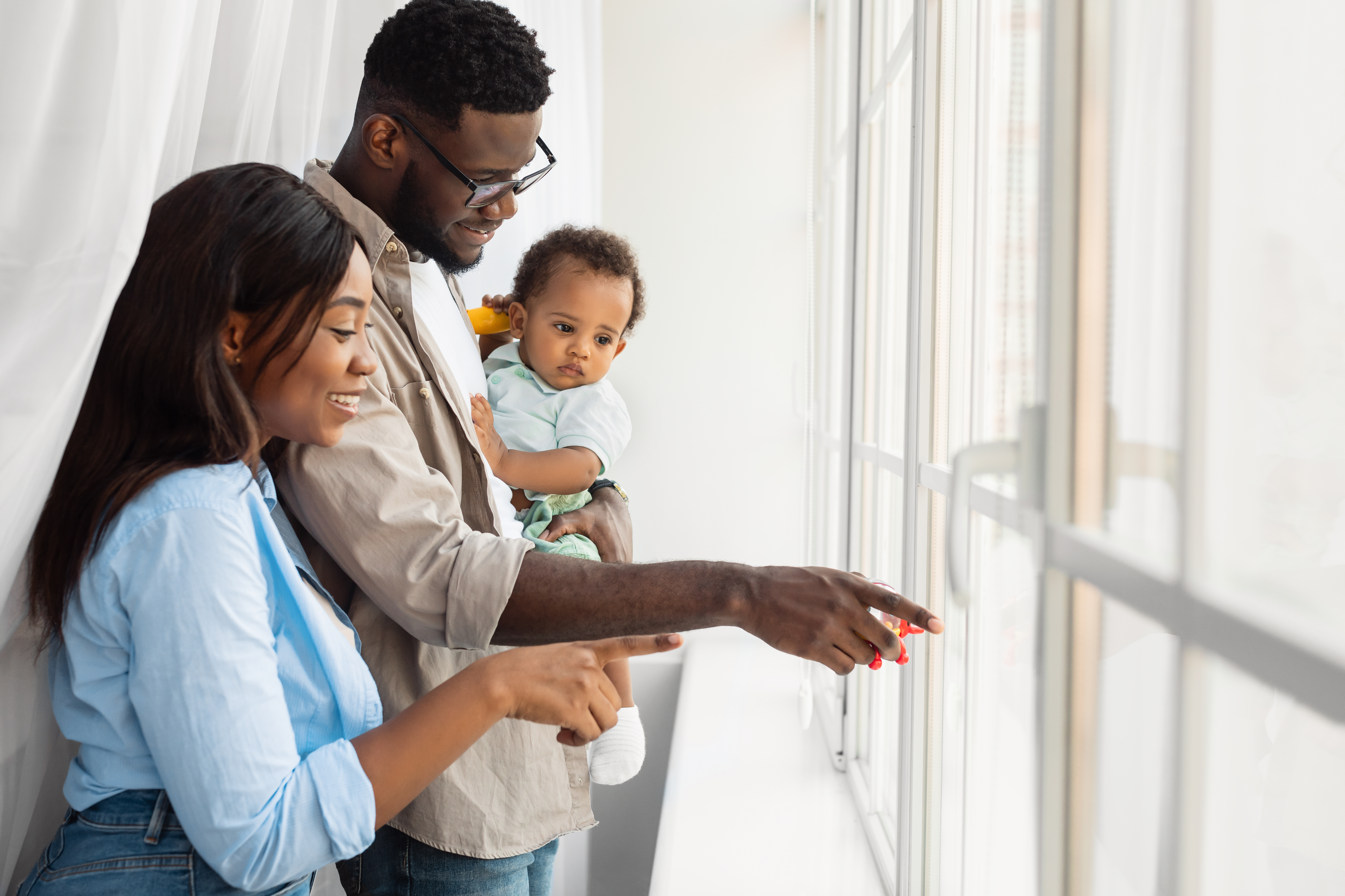 The parents install window guards and safety locks to prevent the baby from falling. The parents install window guards and safety locks to prevent the baby from falling.