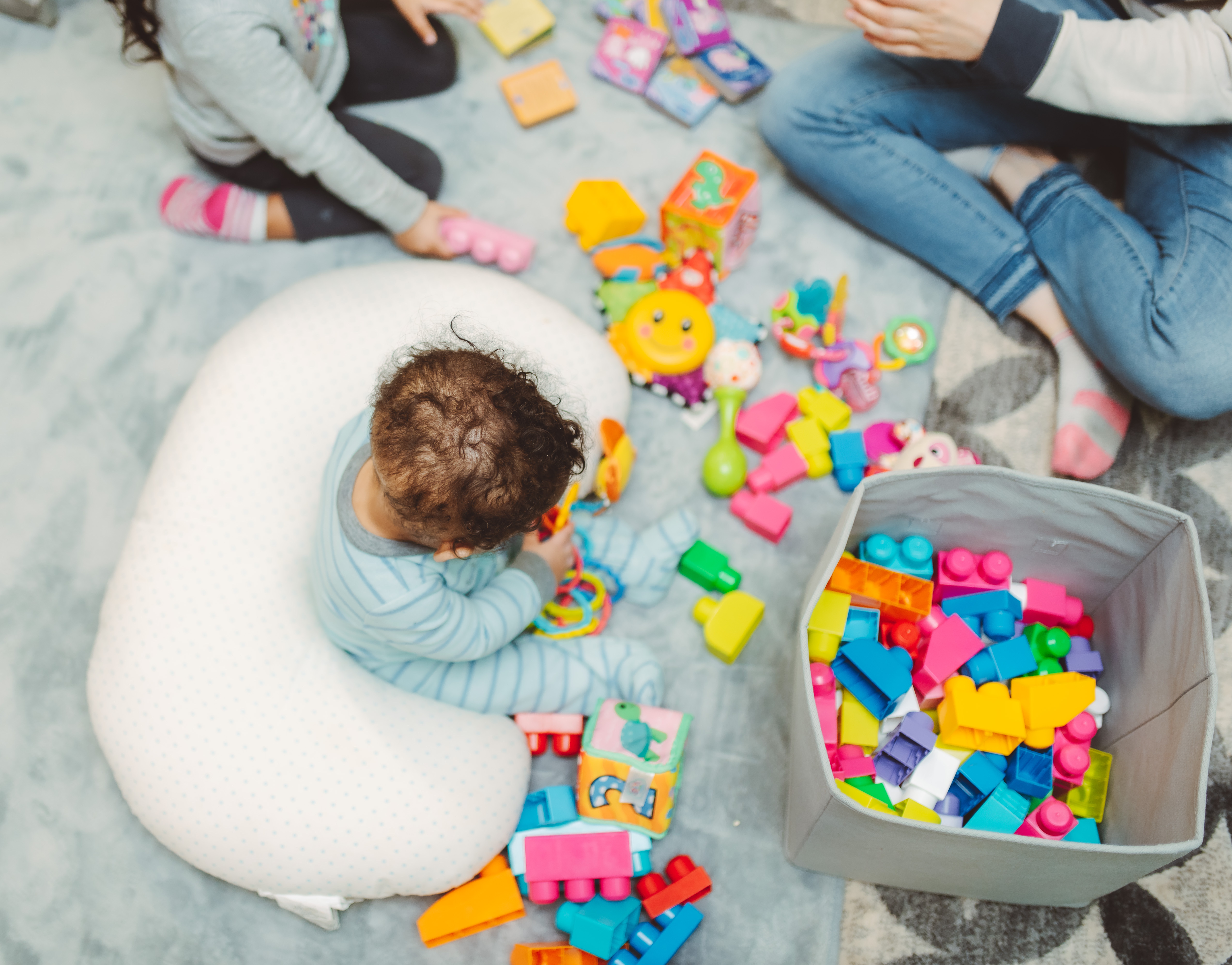 The mother always cleans up or tidies away toys, especially small items that could be harmful to the children. The mother always cleans up or tidies away toys, especially small items that could be harmful to the children.