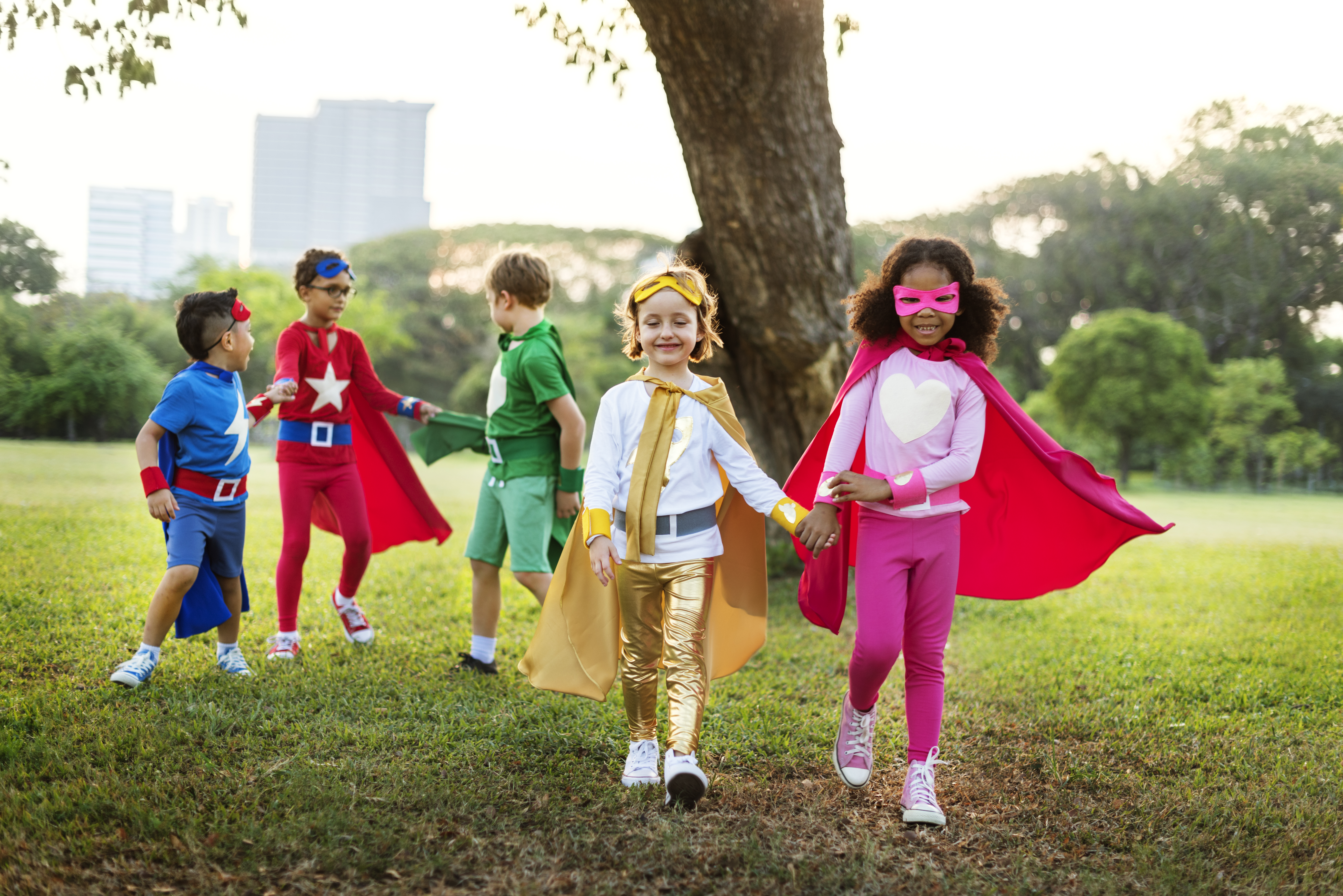 A group of children are playing pretend, acting as superheroes. A group of children are playing pretend, acting as superheroes.