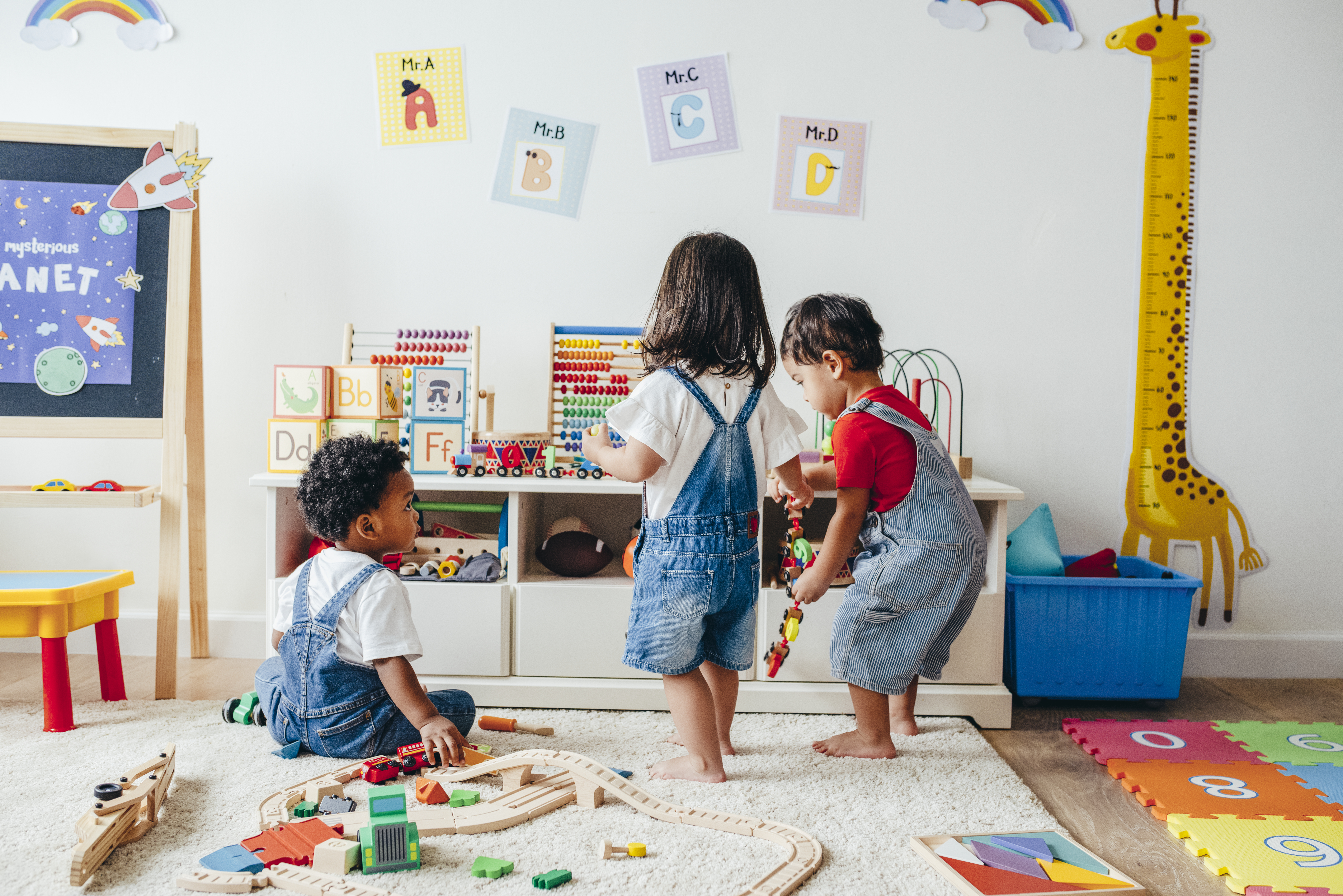 This is a playroom where children can freely explore and where toys are easily accessible and organized. This is a playroom where children can freely explore and where toys are easily accessible and organized.