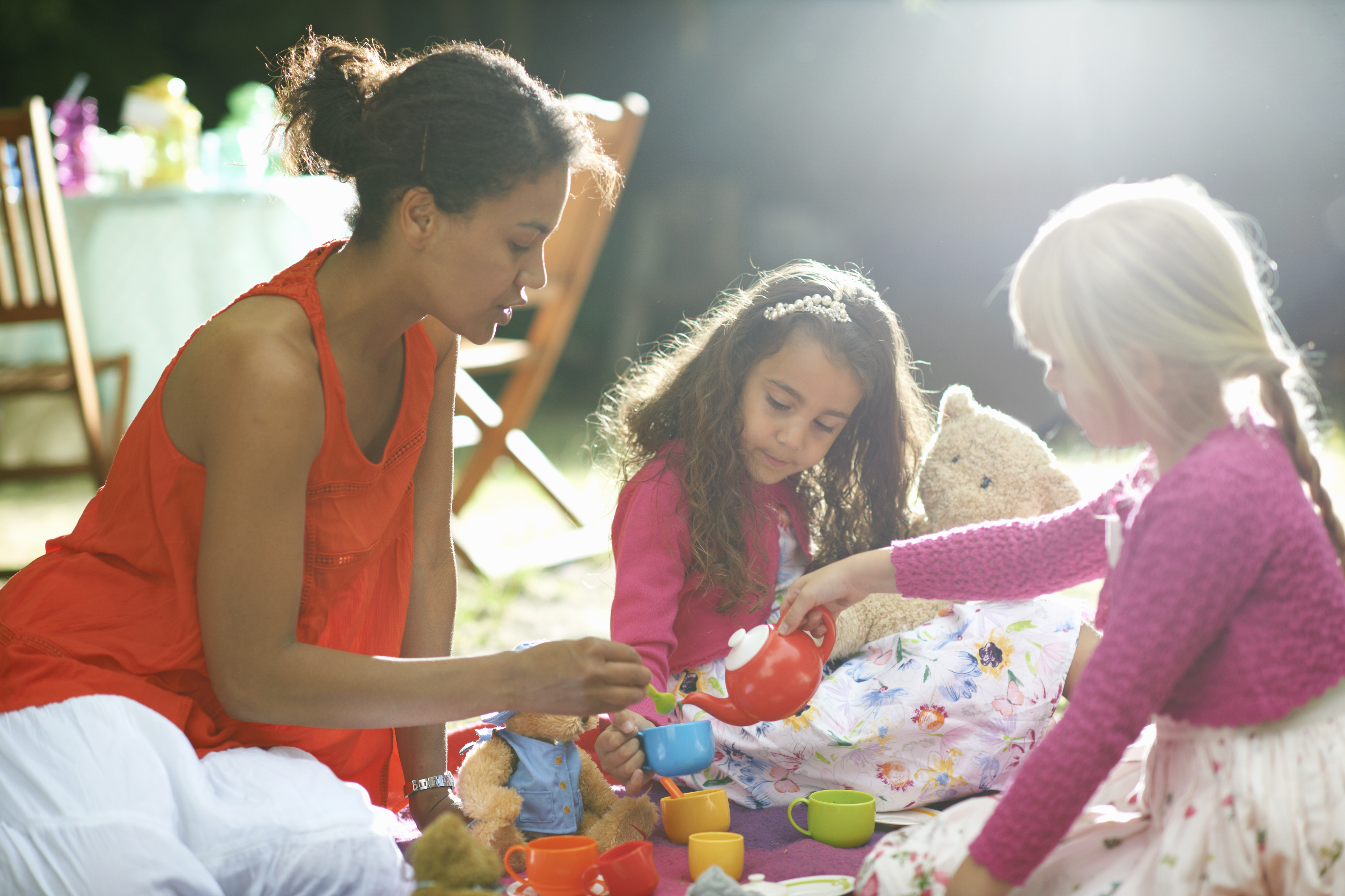 The mother teaches the child about sharing toys and social skills. The mother teaches the child about sharing toys and social skills.