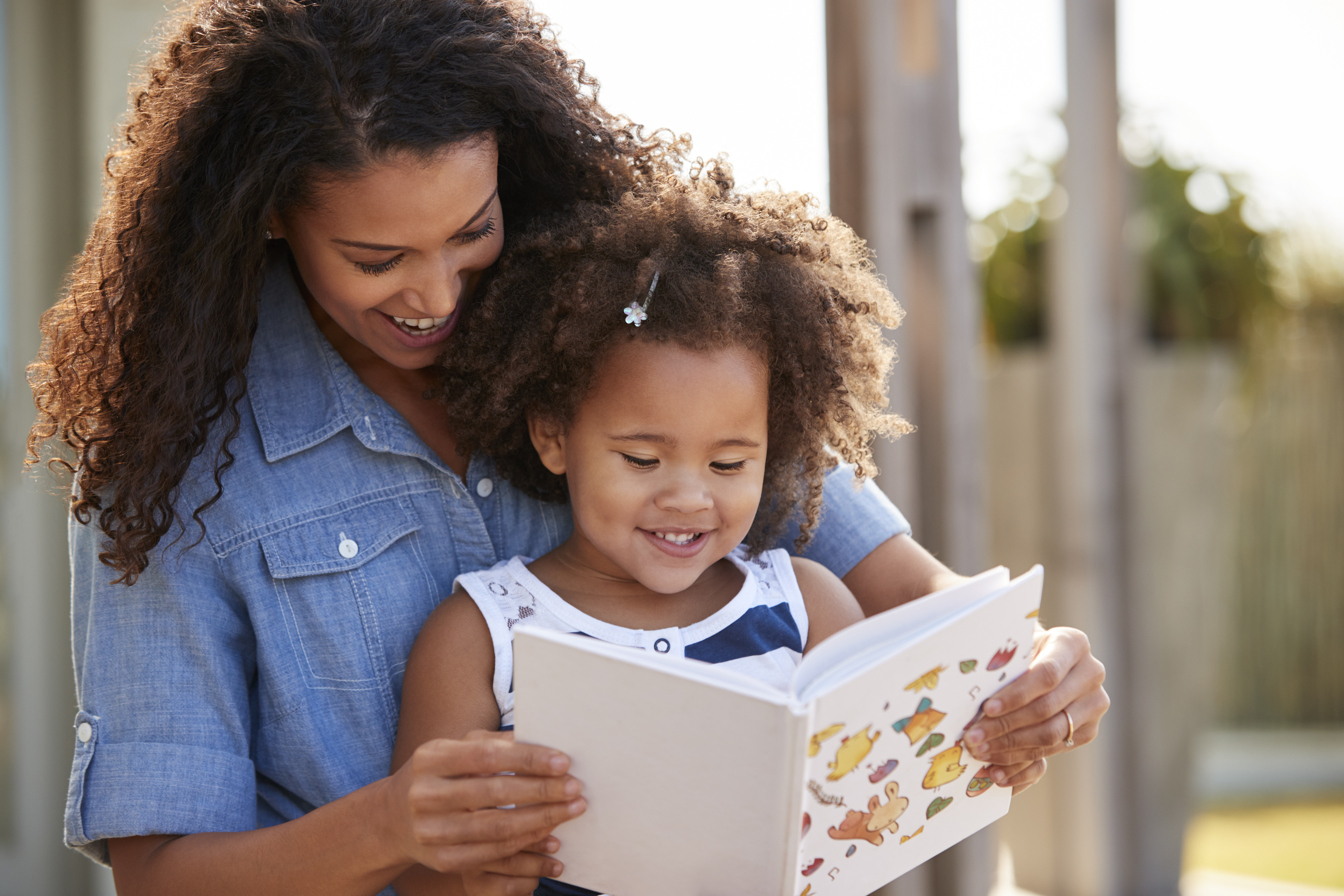 The mother reads colorful books to her child to expand their knowledge, skills, and imagination. The mother reads colorful books to her child to expand their knowledge, skills, and imagination.