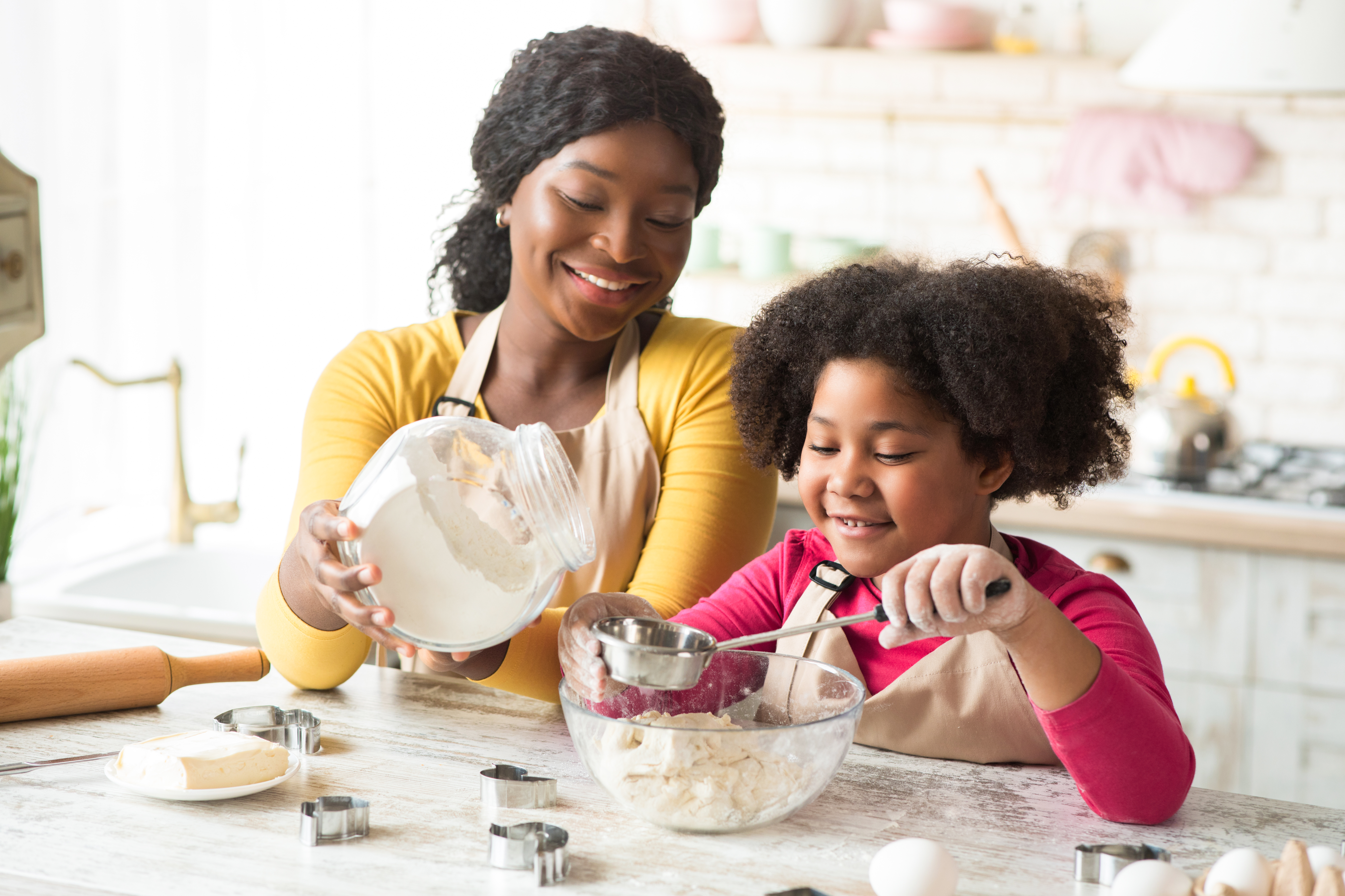 The mother teaches her child practical lessons, such as the joy of making delicious food together. The mother teaches her child practical lessons, such as the joy of making delicious food together.