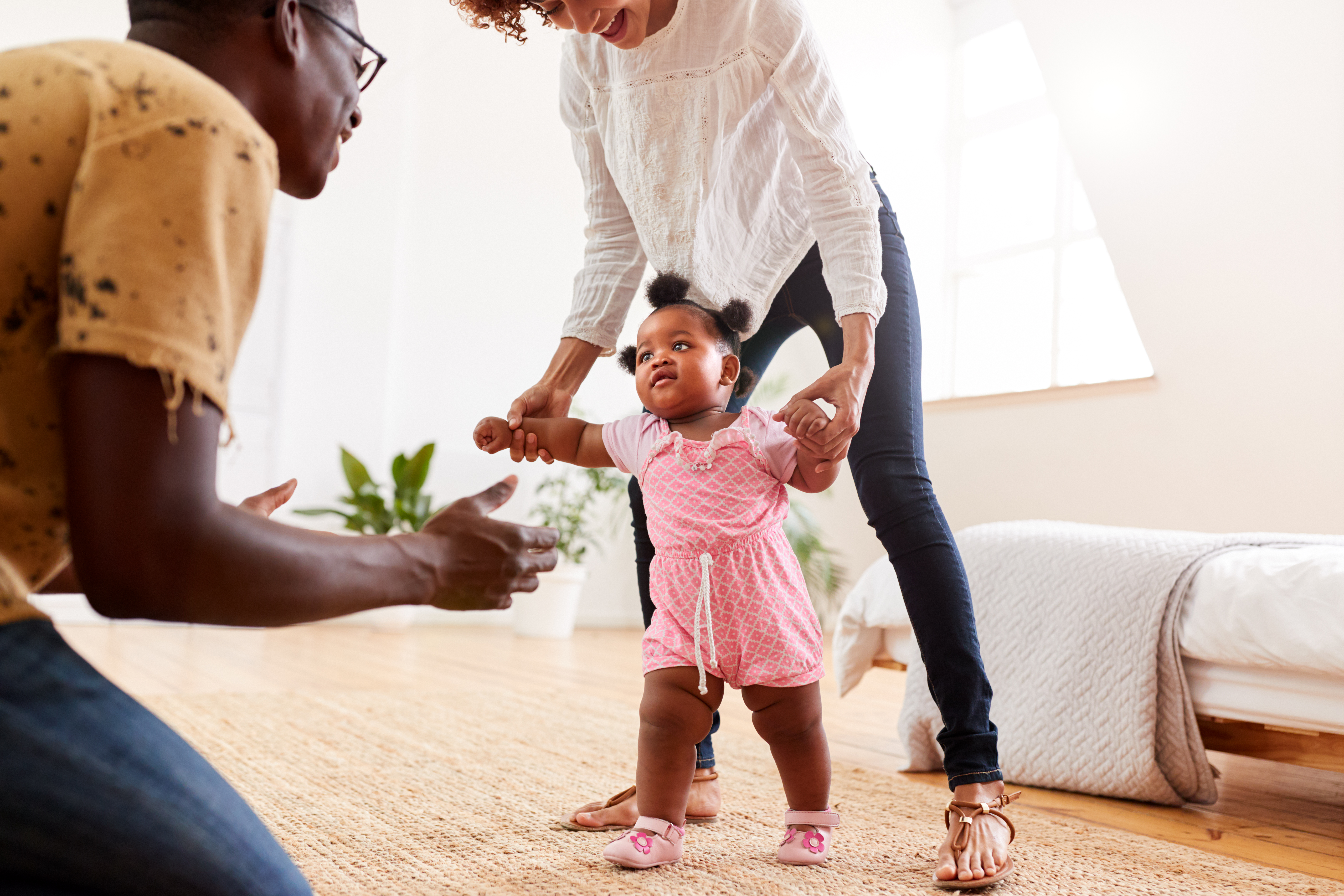 The parents happily cheered as the child learned to walk. The parents happily cheered as the child learned to walk.