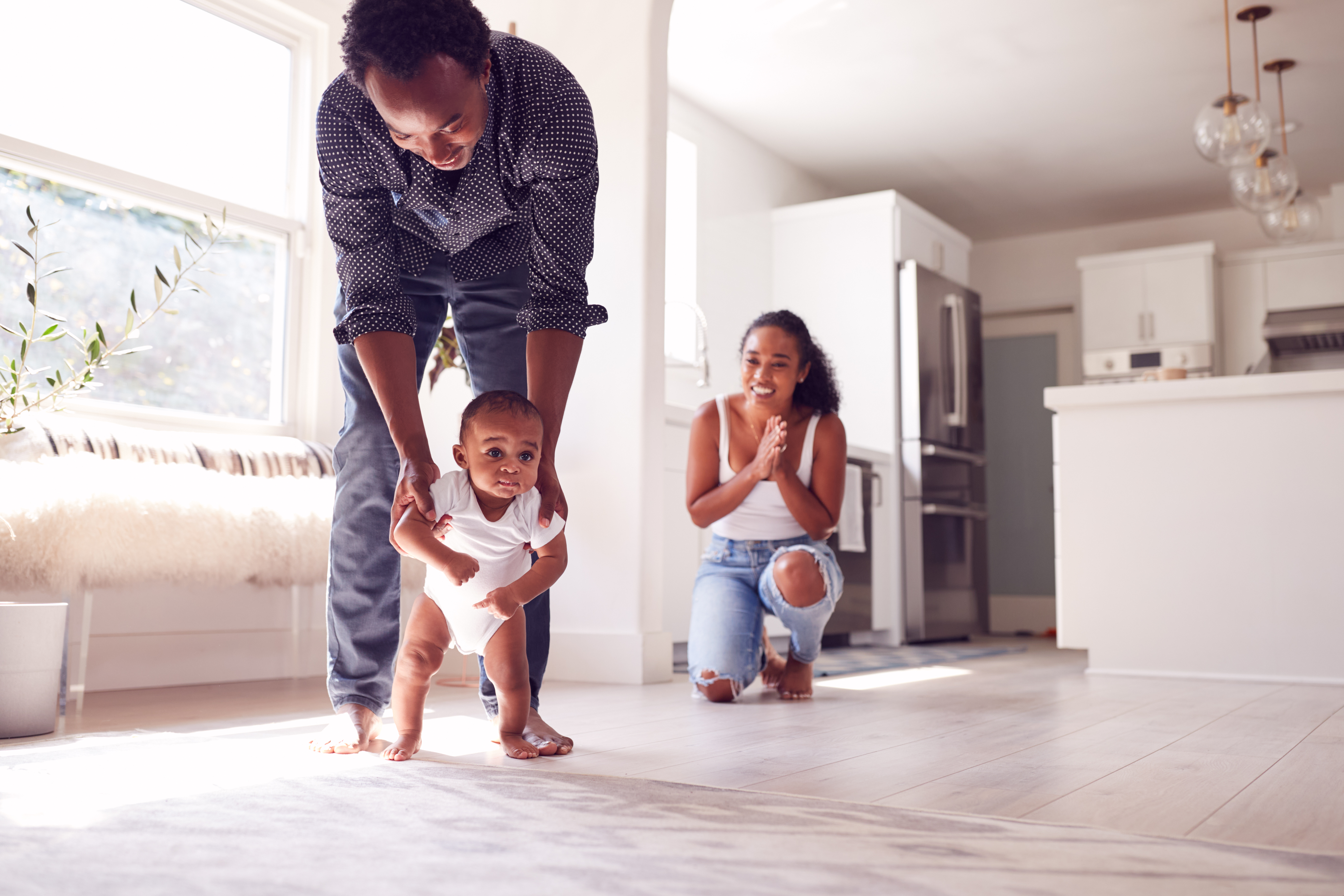 The parents happily support their child in learning and building skills as they grow. The parents happily support their child in learning and building skills as they grow.