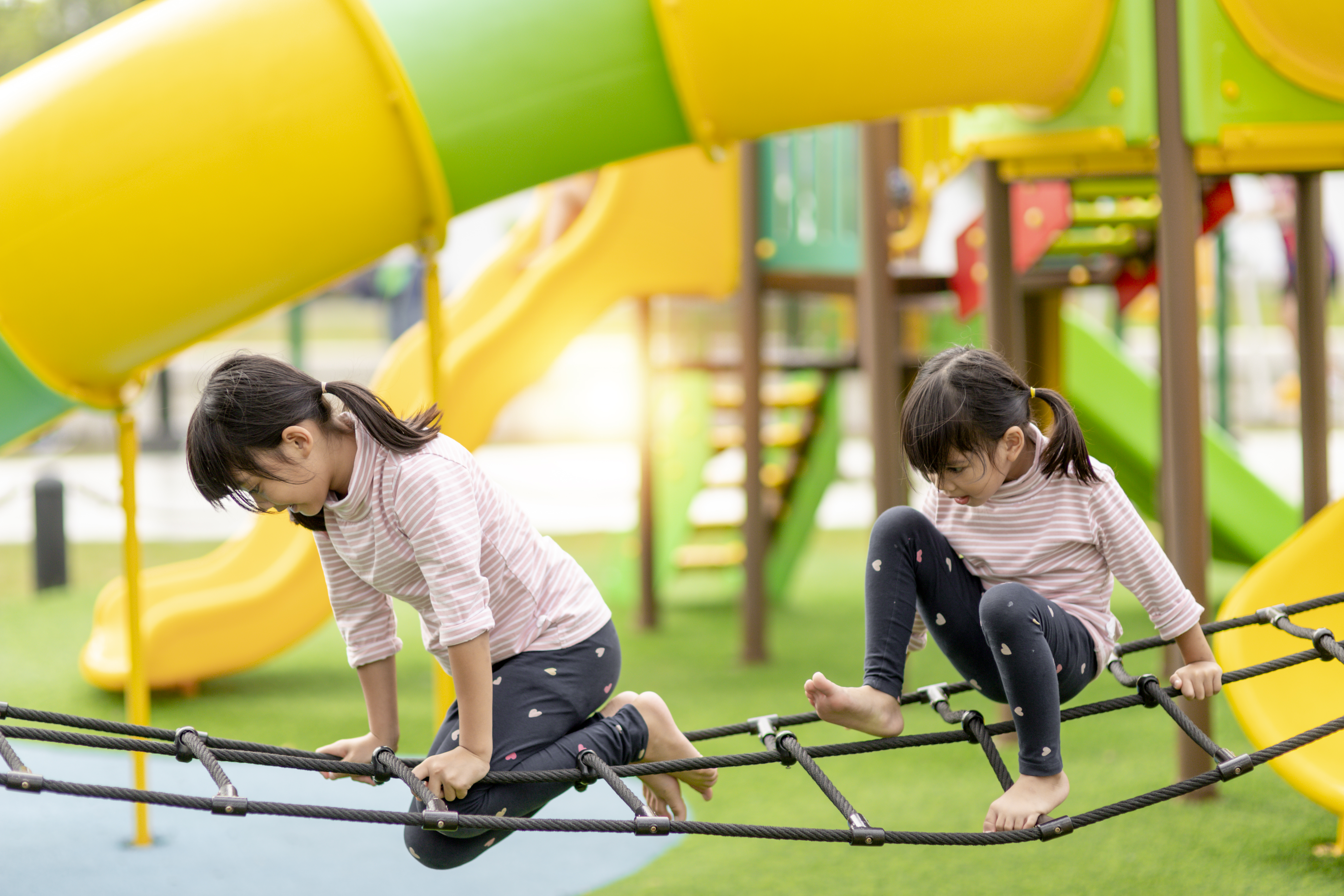 The two children are engaging in an activity that involves coordination and boosts their self-confidence. The two children are engaging in an activity that involves coordination and boosts their self-confidence.