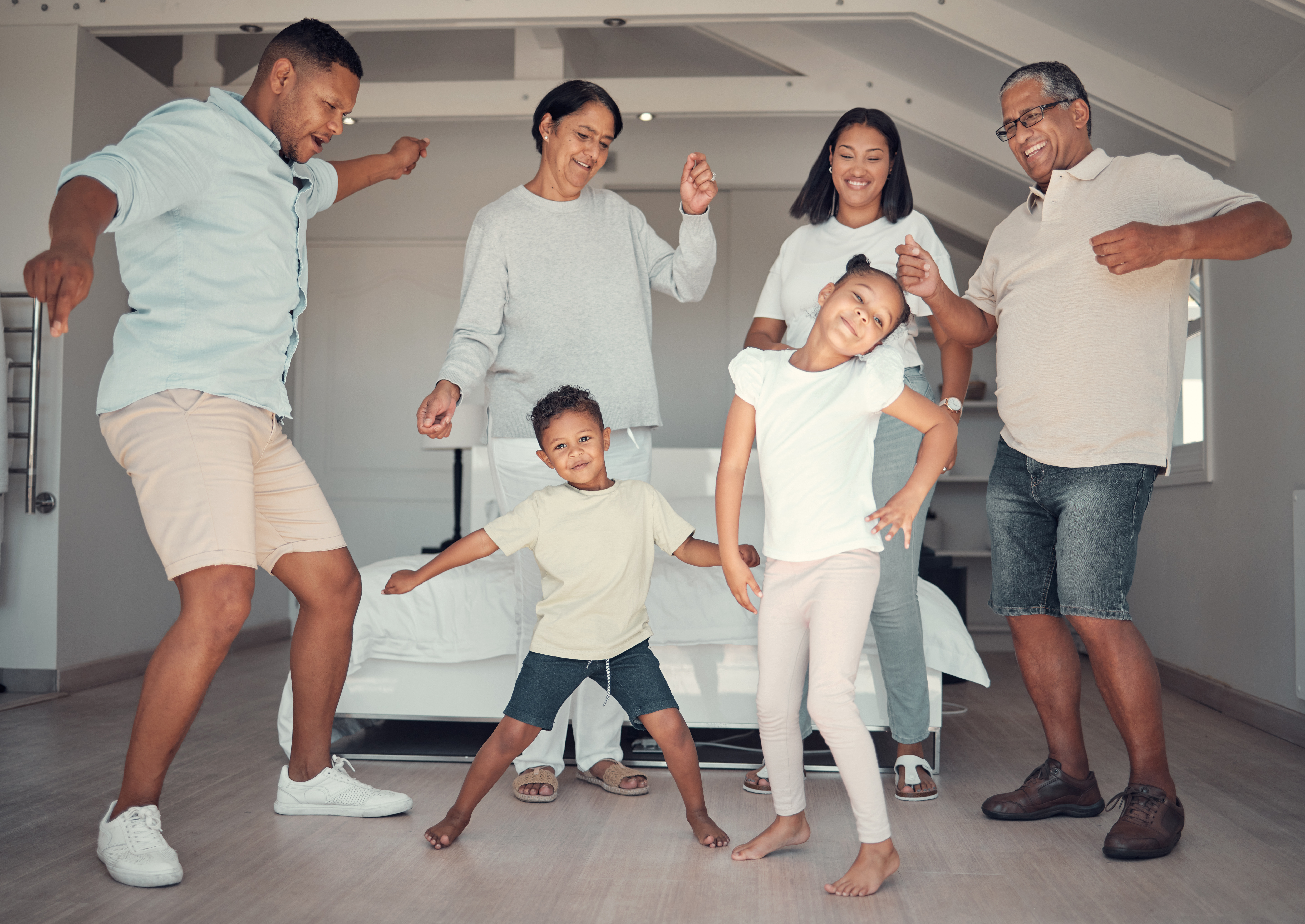 The family is happily dancing together with coordination and a positive connection. The family is happily dancing together with coordination and a positive connection.