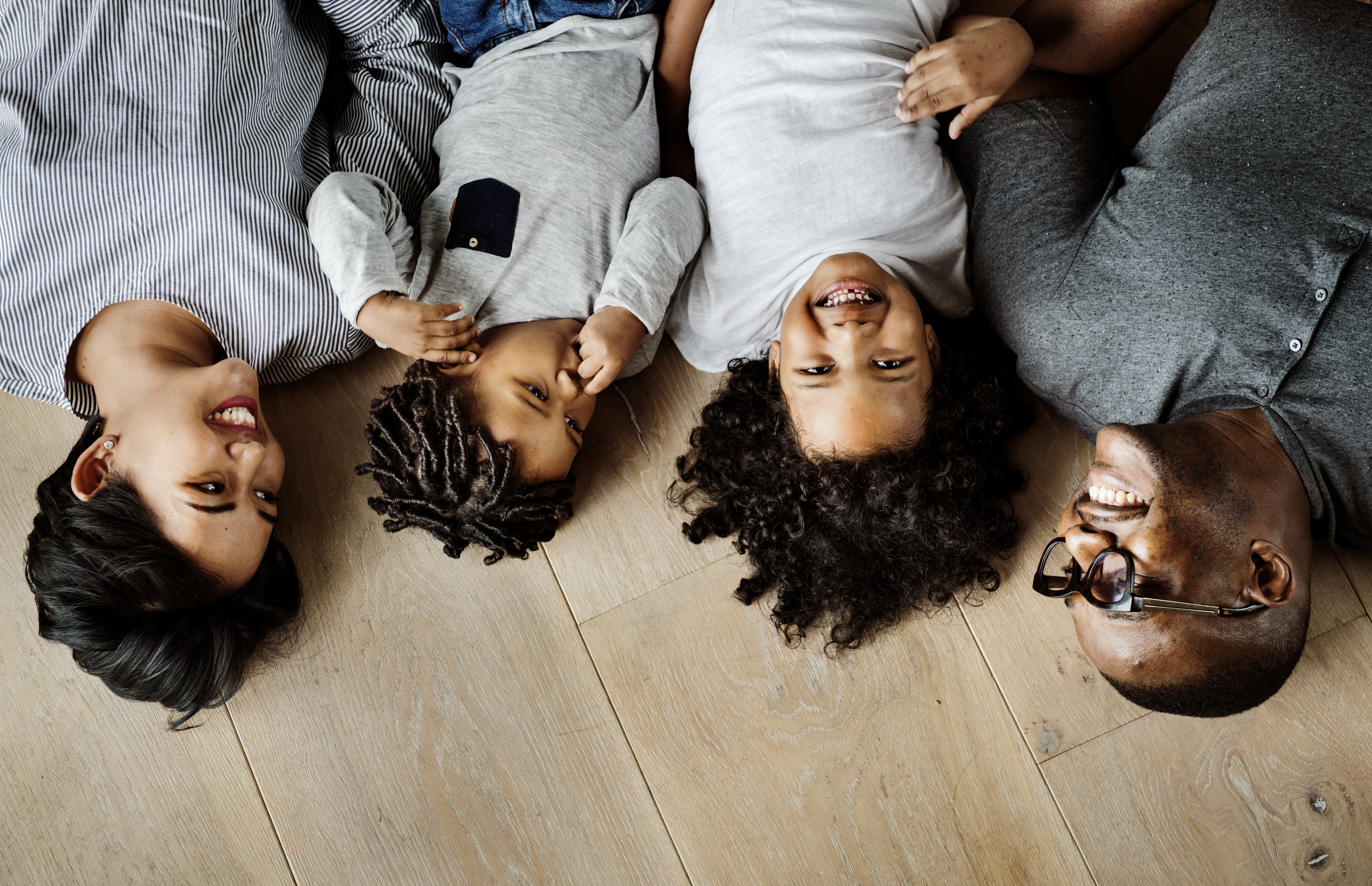 Family lying down on the floor Family lying down on the floor
