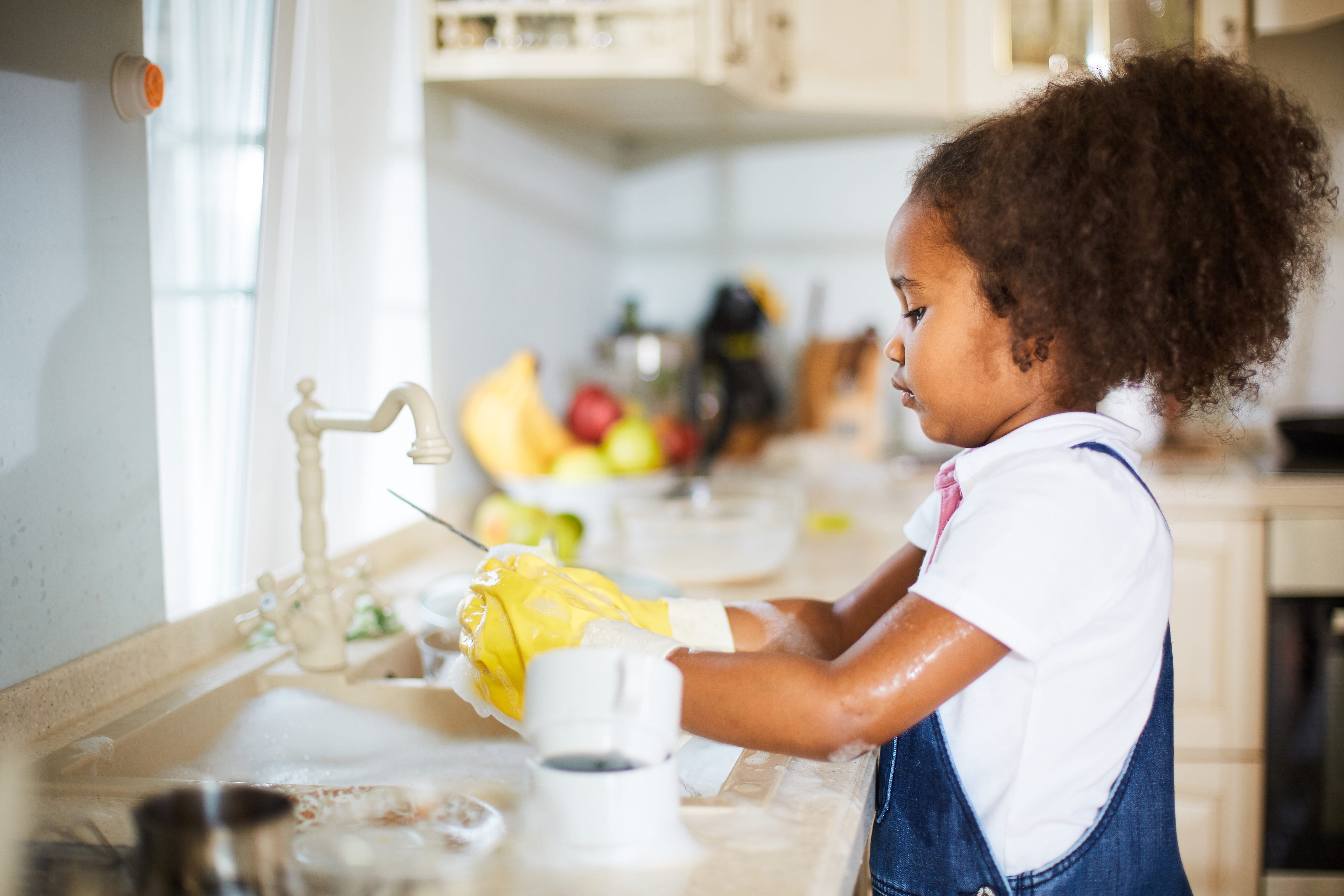 Little girl washing the dishes Little girl washing the dishes