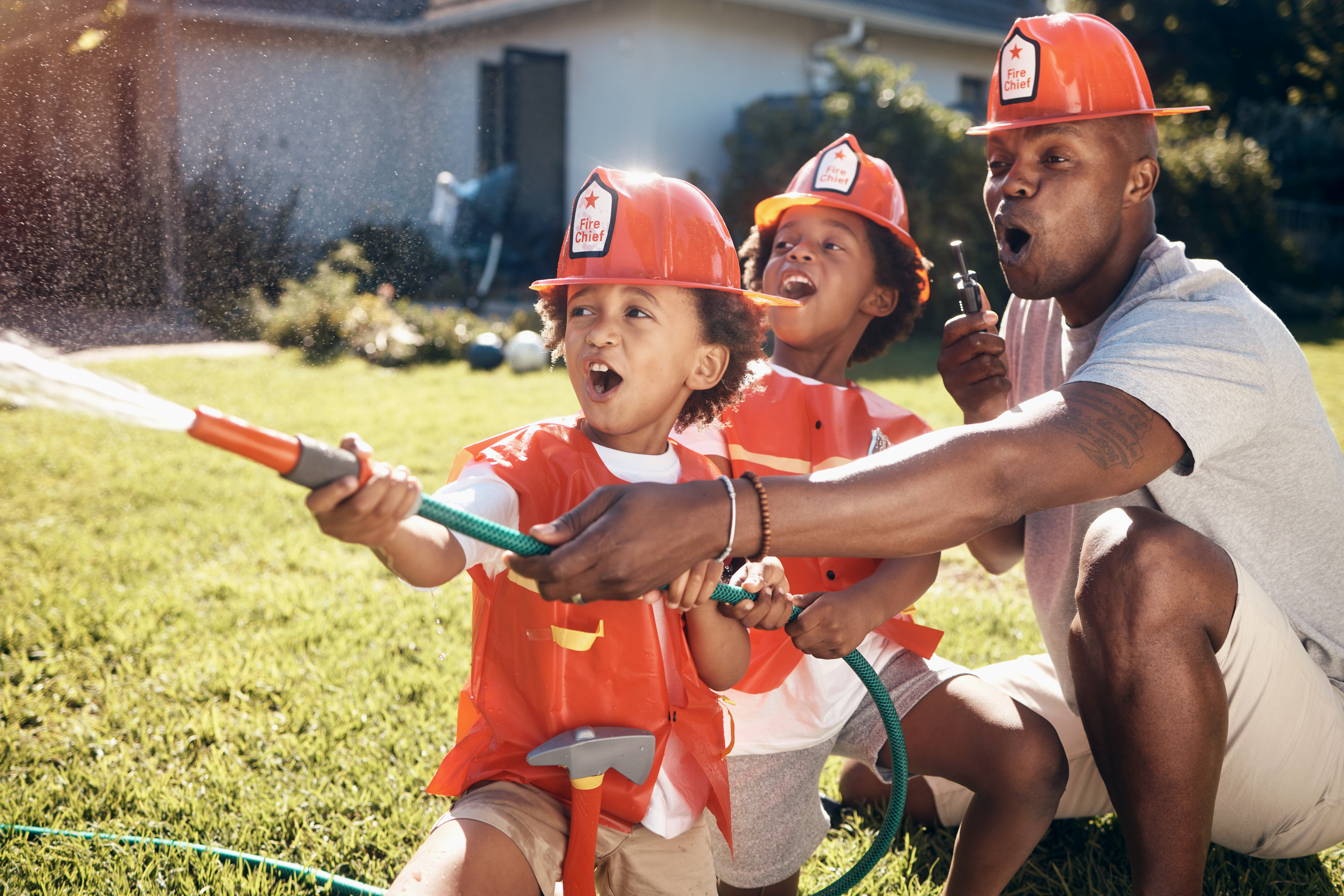 Father and kids playing as a fireman Father and kids playing as a fireman