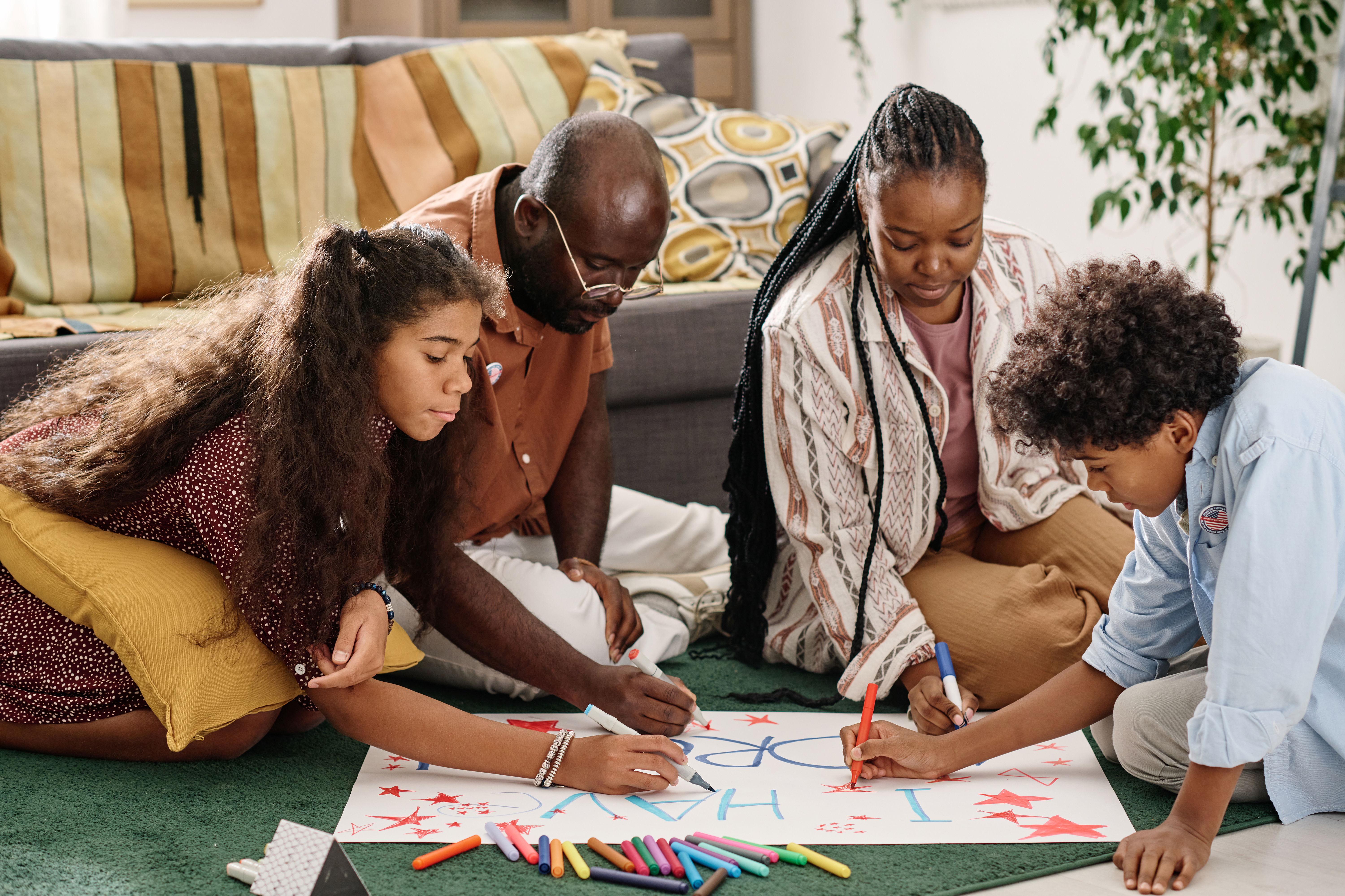 Family helping together to make a placard Family helping together to make a placard