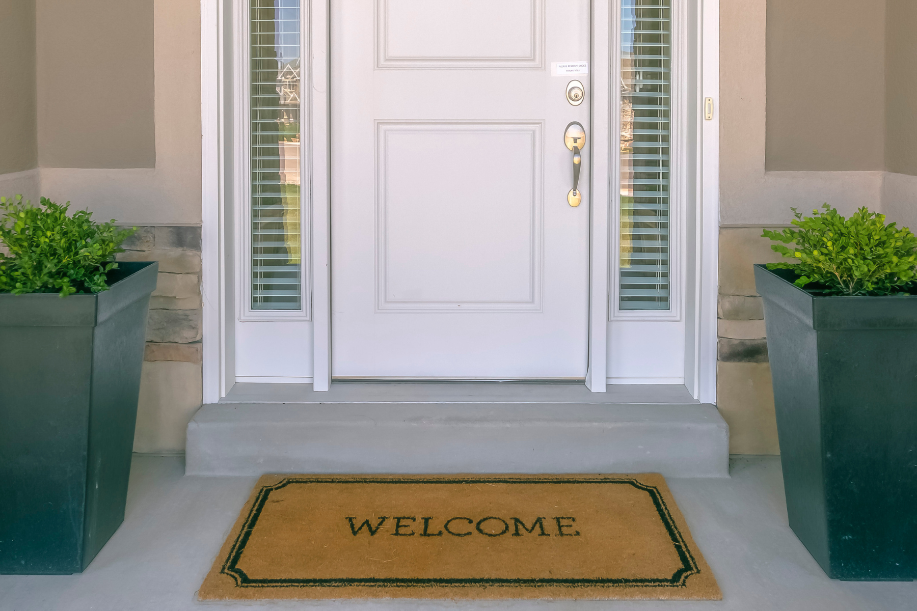 This inviting front porch scene features a clean white door framed by symmetrical planters and a simple “Welcome” mat—showcasing how small, affordable touches can instantly boost curb appeal. This inviting front porch scene features a clean white door framed by symmetrical planters and a simple “Welcome” mat—showcasing how small, affordable touches can instantly boost curb appeal.
