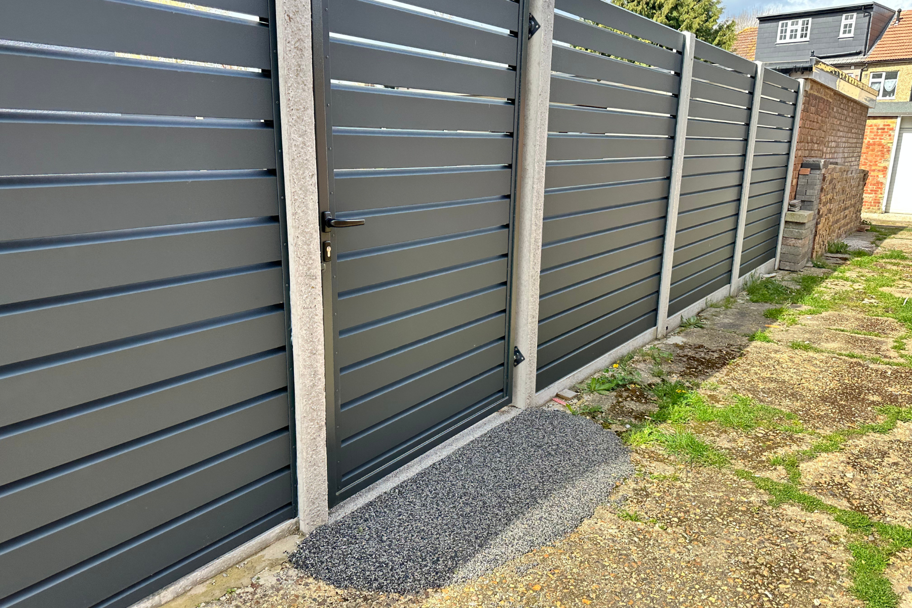 This image showcases a sleek, modern privacy fence in dark gray with clean horizontal panels—demonstrating how updated fencing can instantly elevate curb appeal and create a polished, secure look. This image showcases a sleek, modern privacy fence in dark gray with clean horizontal panels—demonstrating how updated fencing can instantly elevate curb appeal and create a polished, secure look.