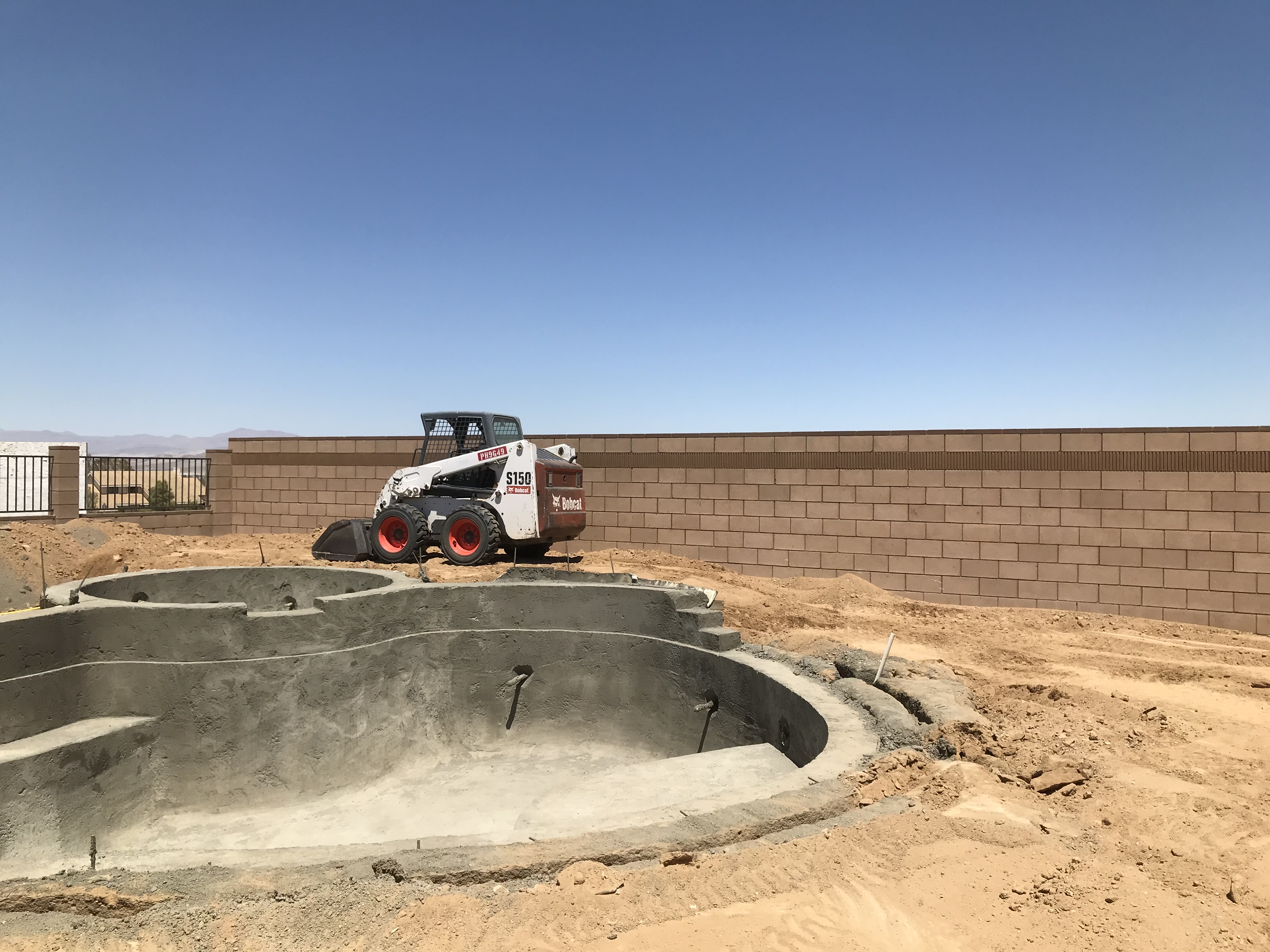 Pool construction in Ridgecrest — custom pool builder preparing steel and plumbing for new build
