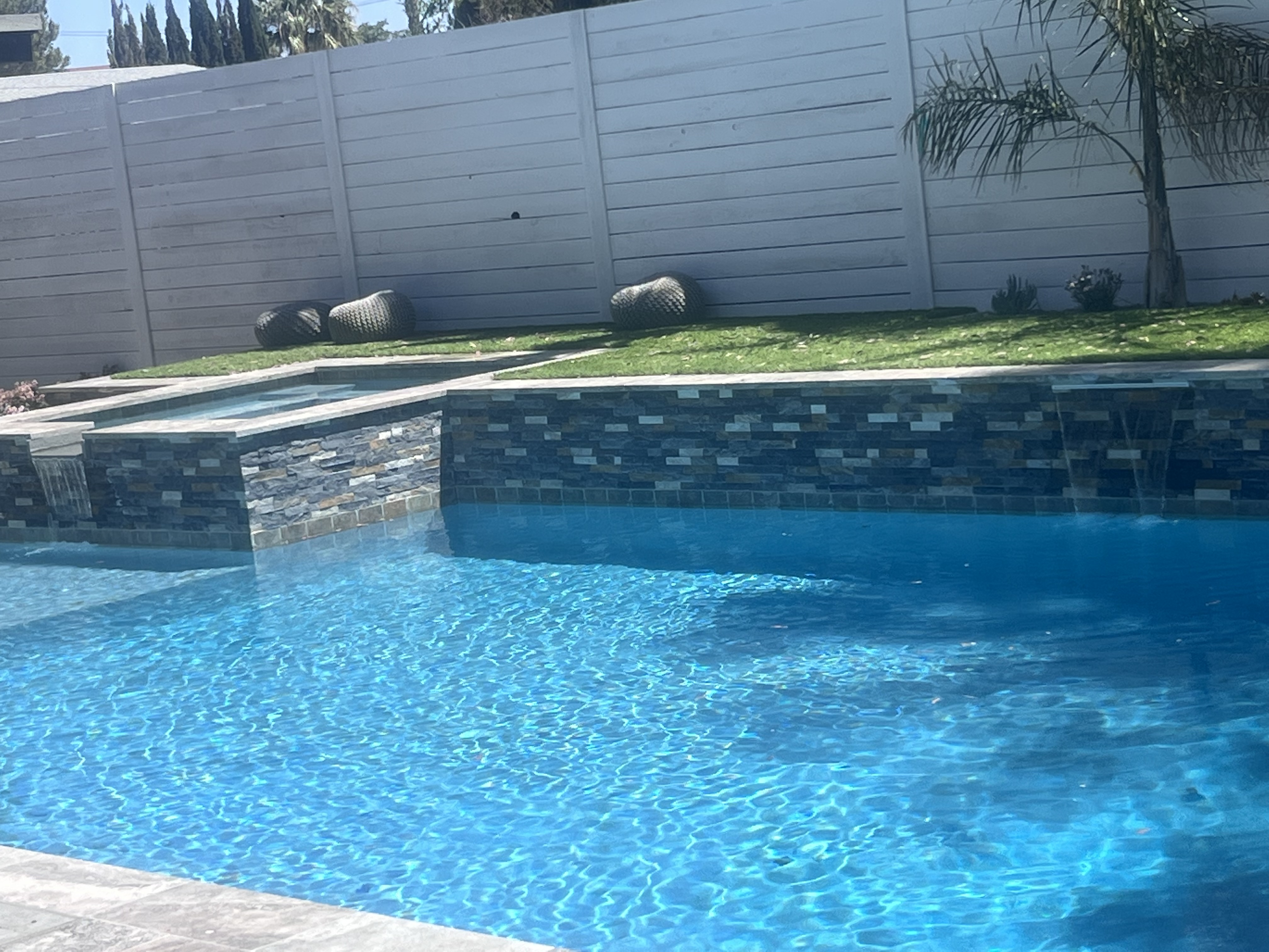 Custom pool builder contractor — geometric pool with Baja shelf and energy-efficient equipment