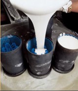 Pouring casting plaster into a flask containing jewellery tree Pouring casting plaster into a flask containing jewellery tree