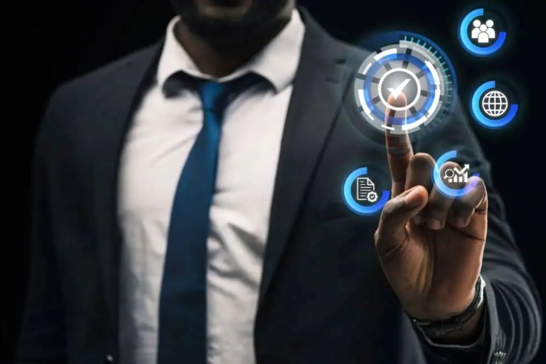  A professional in a suit interacts with a transparent digital interface, demonstrating the benefits of REI CRM systems from AMPLIFIREI.