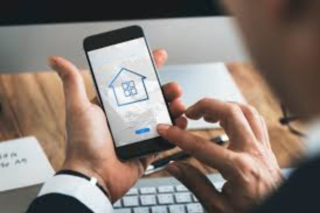 A person using a smartphone with a house icon on the screen, representing SMS marketing for property investors by AMPLIFIREI. A person using a smartphone with a house icon on the screen, representing SMS marketing for property investors by AMPLIFIREI.