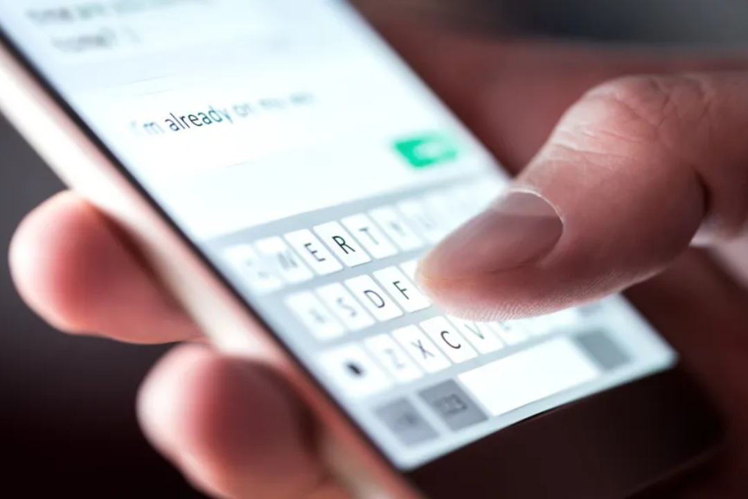 A man typing on a phone with a CRM interface overlay, demonstrating SMS marketing for property investors by AMPLIFIREI. A man typing on a phone with a CRM interface overlay, demonstrating SMS marketing for property investors by AMPLIFIREI.