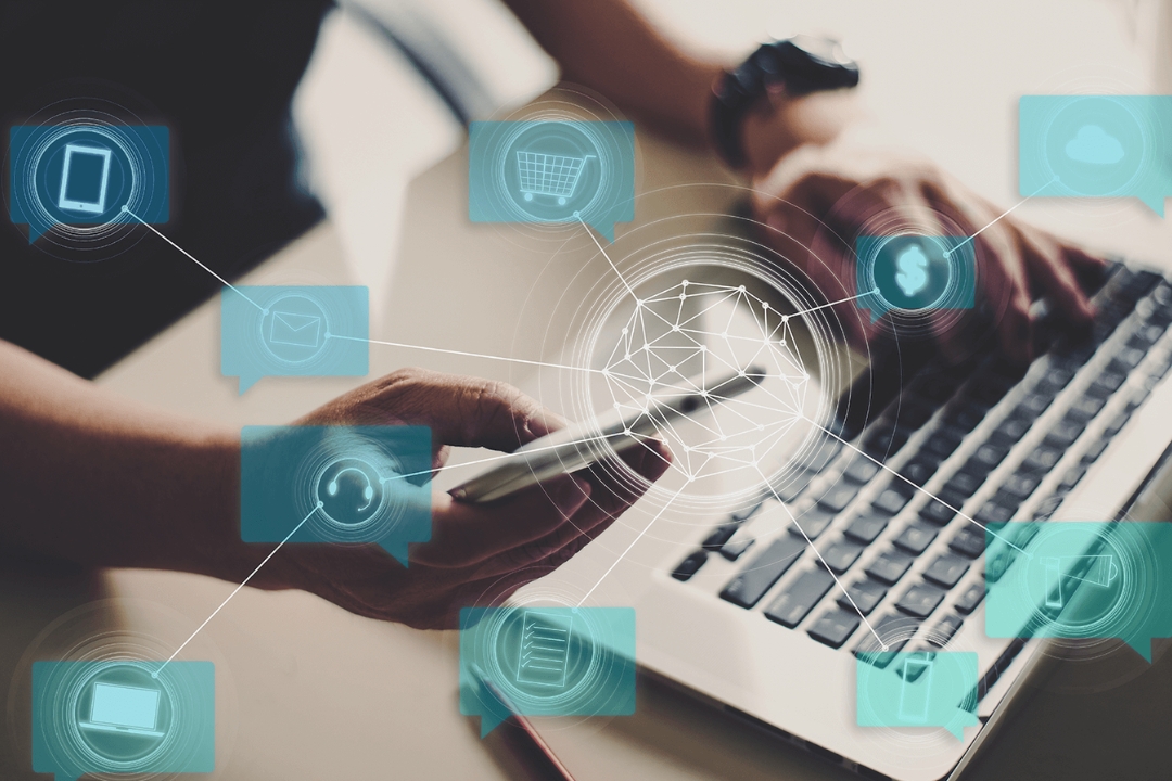 An individual manages multiple tasks on a phone and laptop, demonstrating AMPLIFIREI's tech for automating investor follow-up. An individual manages multiple tasks on a phone and laptop, demonstrating AMPLIFIREI's tech for automating investor follow-up.