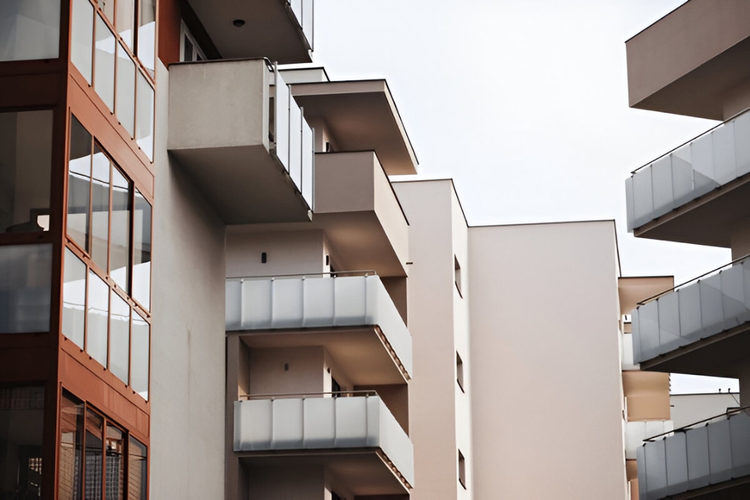 Modern apartment buildings with balconies, showcasing urban growth where effective pipeline management software by AMPLIFIREI ensures smooth operations.