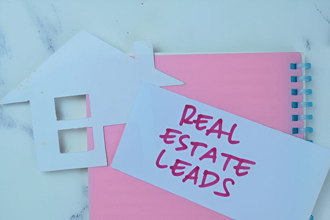 Paper cut house and card with words real estate leads on notebook, automating property follow-up sequences by AMPLIFIREI. Paper cut house and card with words real estate leads on notebook, automating property follow-up sequences by AMPLIFIREI.