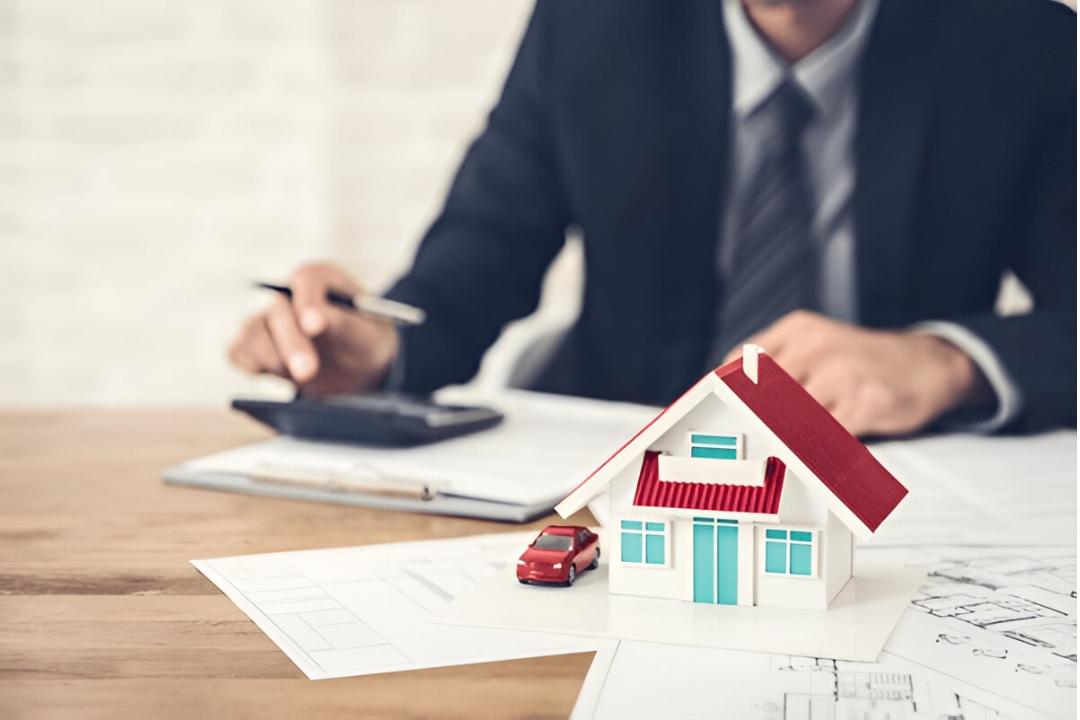 A man works on real estate plans with a toy house and car, a guide on optimizing REI website landing pages by AMPLIFIREI. A man works on real estate plans with a toy house and car, a guide on optimizing REI website landing pages by AMPLIFIREI.